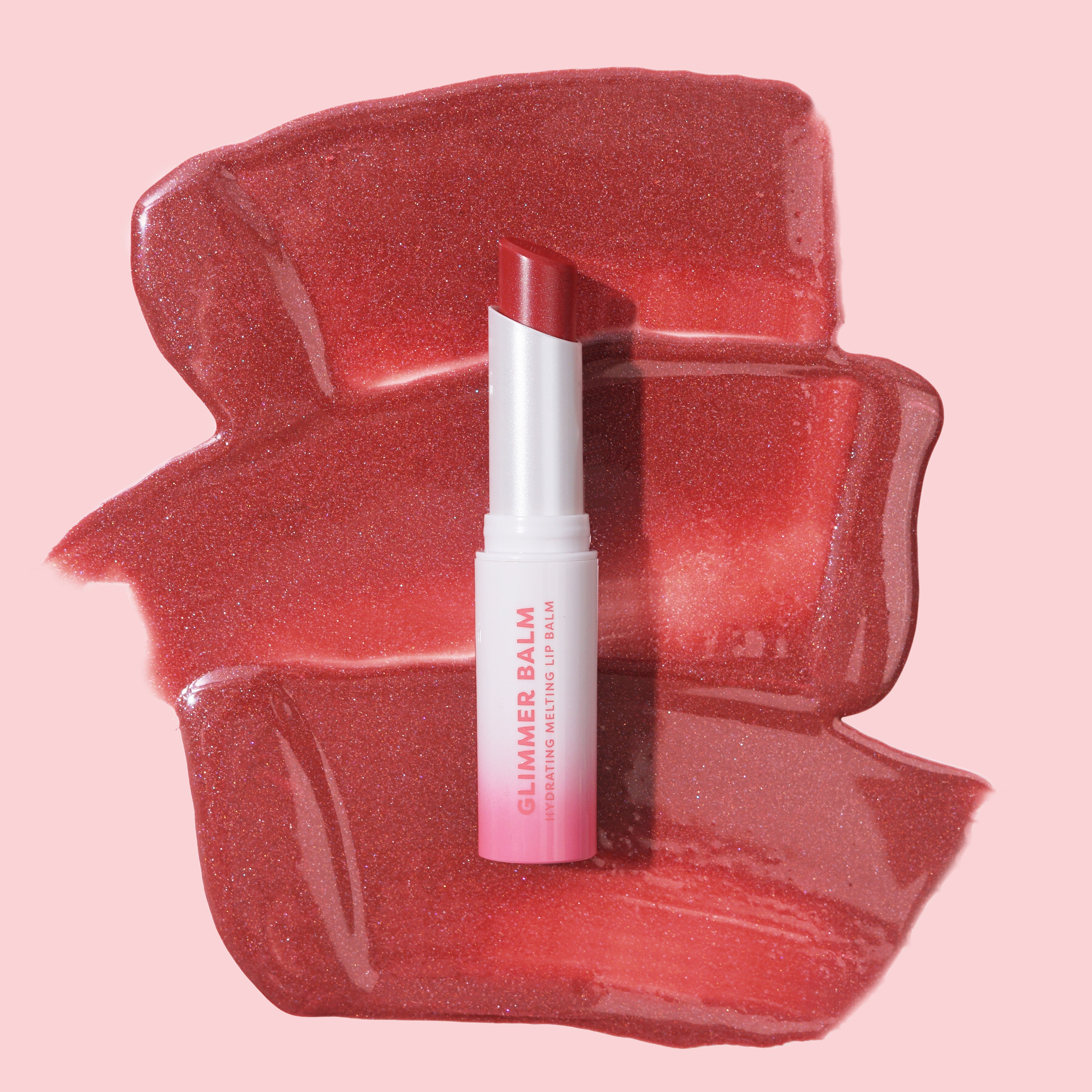 Profusion Cosmetics Glimmer Balm hydrating melting lip balm in coral, showing a smooth, glossy lip with a shimmering finish.