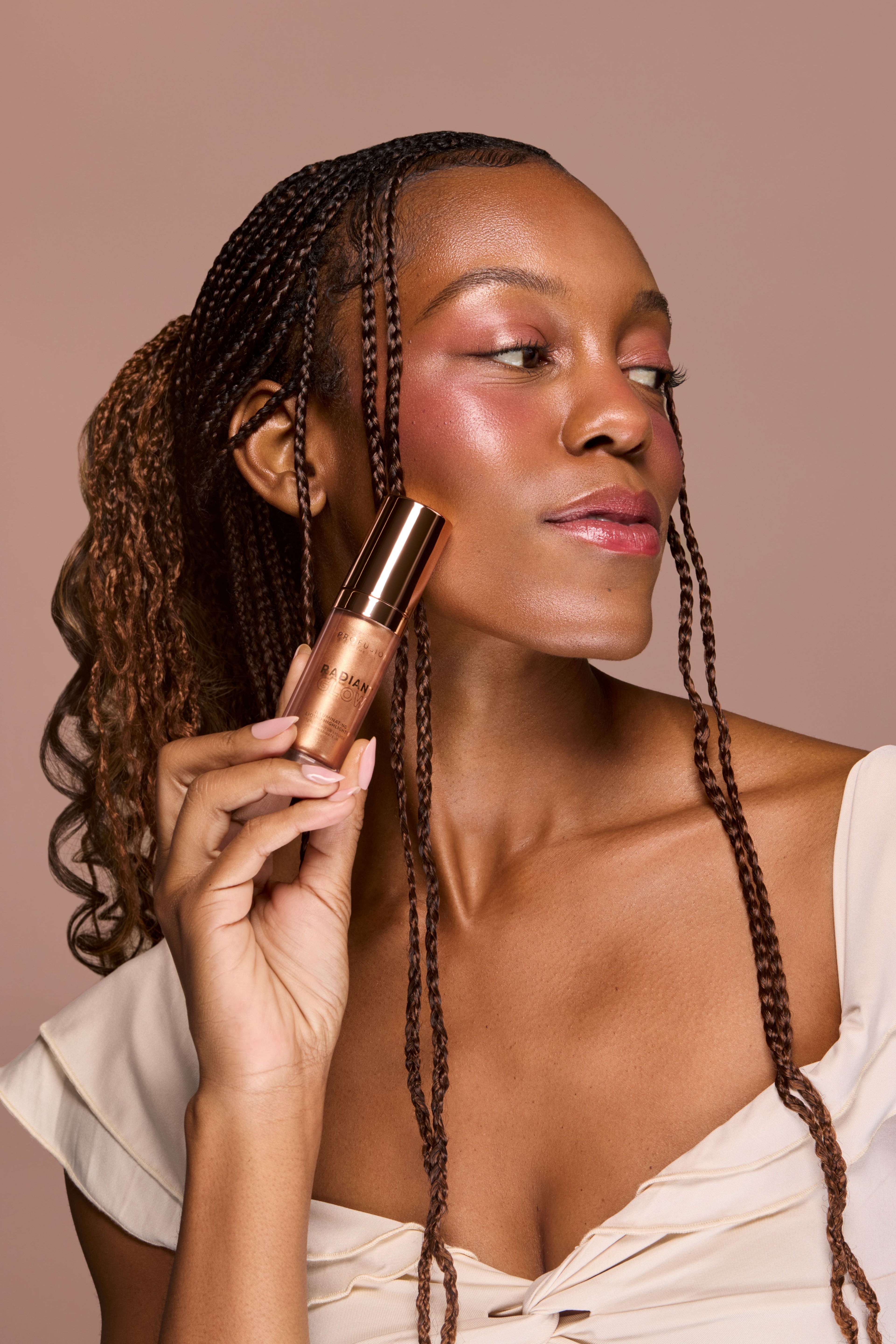 Profusion Cosmetics Radiant Glow Illuminating Liquid Highlighter in champagne shade, showcasing its smooth liquid texture and luminous finish.
