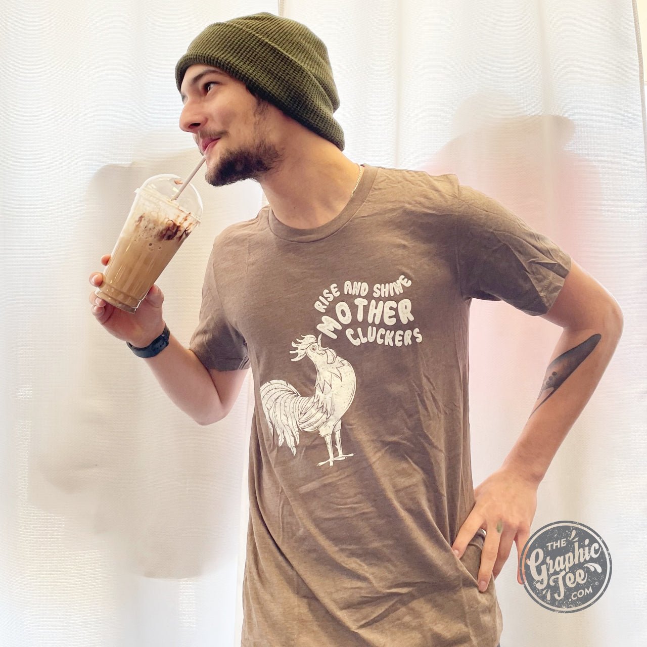 Unisex graphic tee featuring "Rise and Shine Mother Cluckers" print by The Graphic Tee, casual streetwear style.