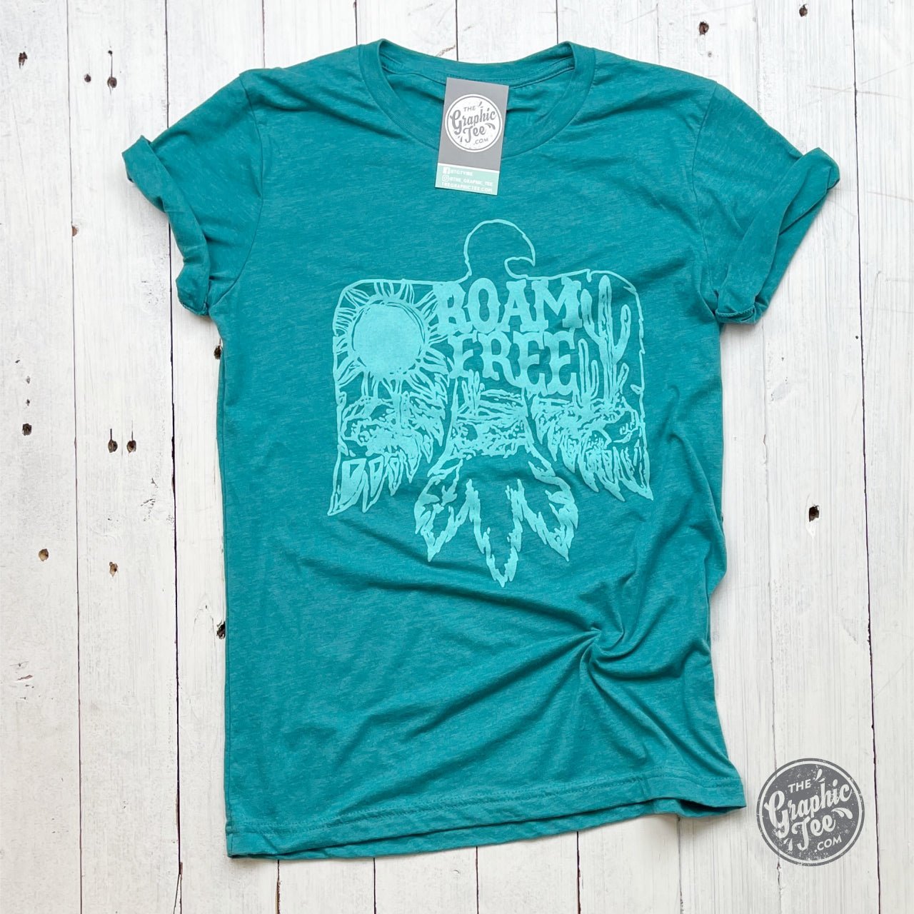 Roam Free teal crewneck short sleeve unisex graphic tee by The Graphic Tee, featuring a casual design and vibrant color.