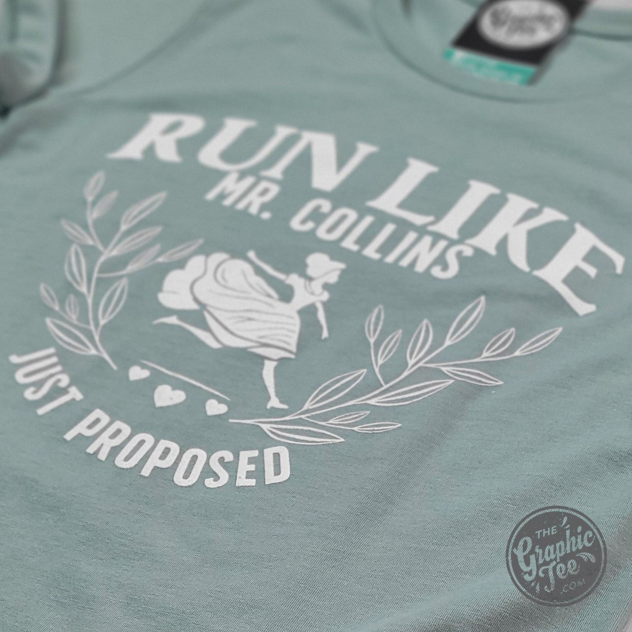 Men's short sleeve graphic tee featuring "Run Like Mr. Collins Just Proposed" design by The Graphic Tee.