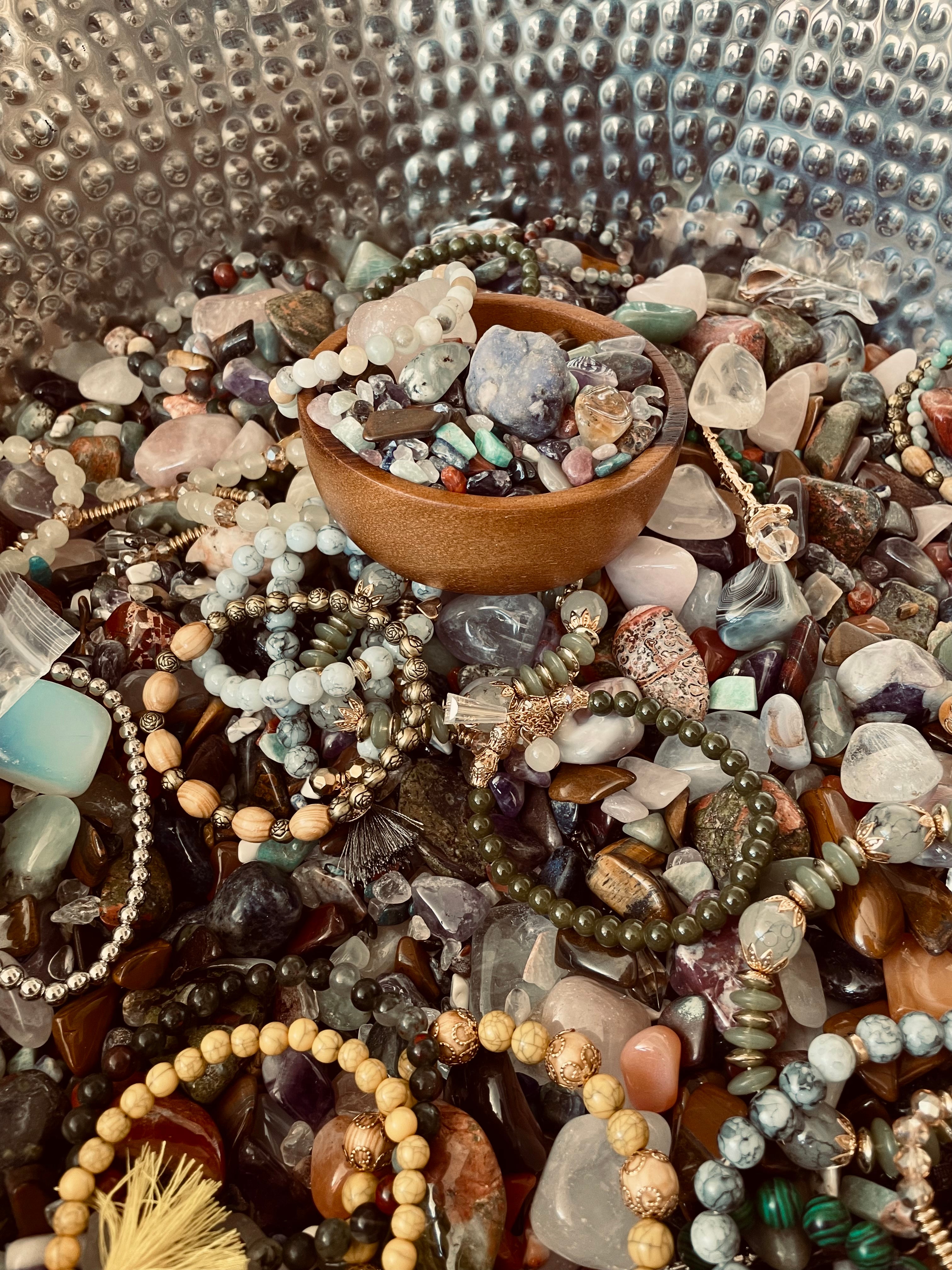 Close-up of colorful Sage & Stone Apothecary Crystal Confetti crystals in various shapes and sizes on a white background.