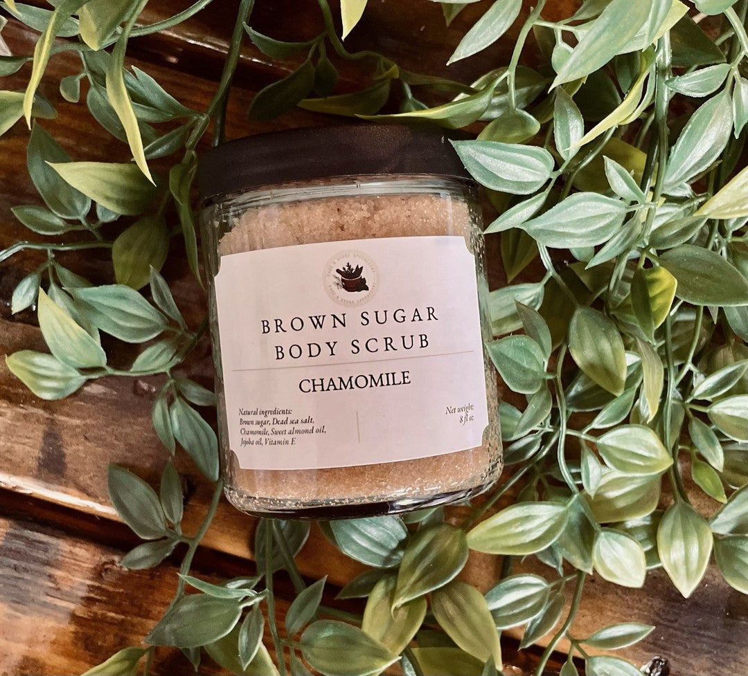 Brown Sugar Chamomile Scrub from Sage & Stone Apothecary, close-up of natural exfoliating scrub with brown sugar and chamomile flowers.