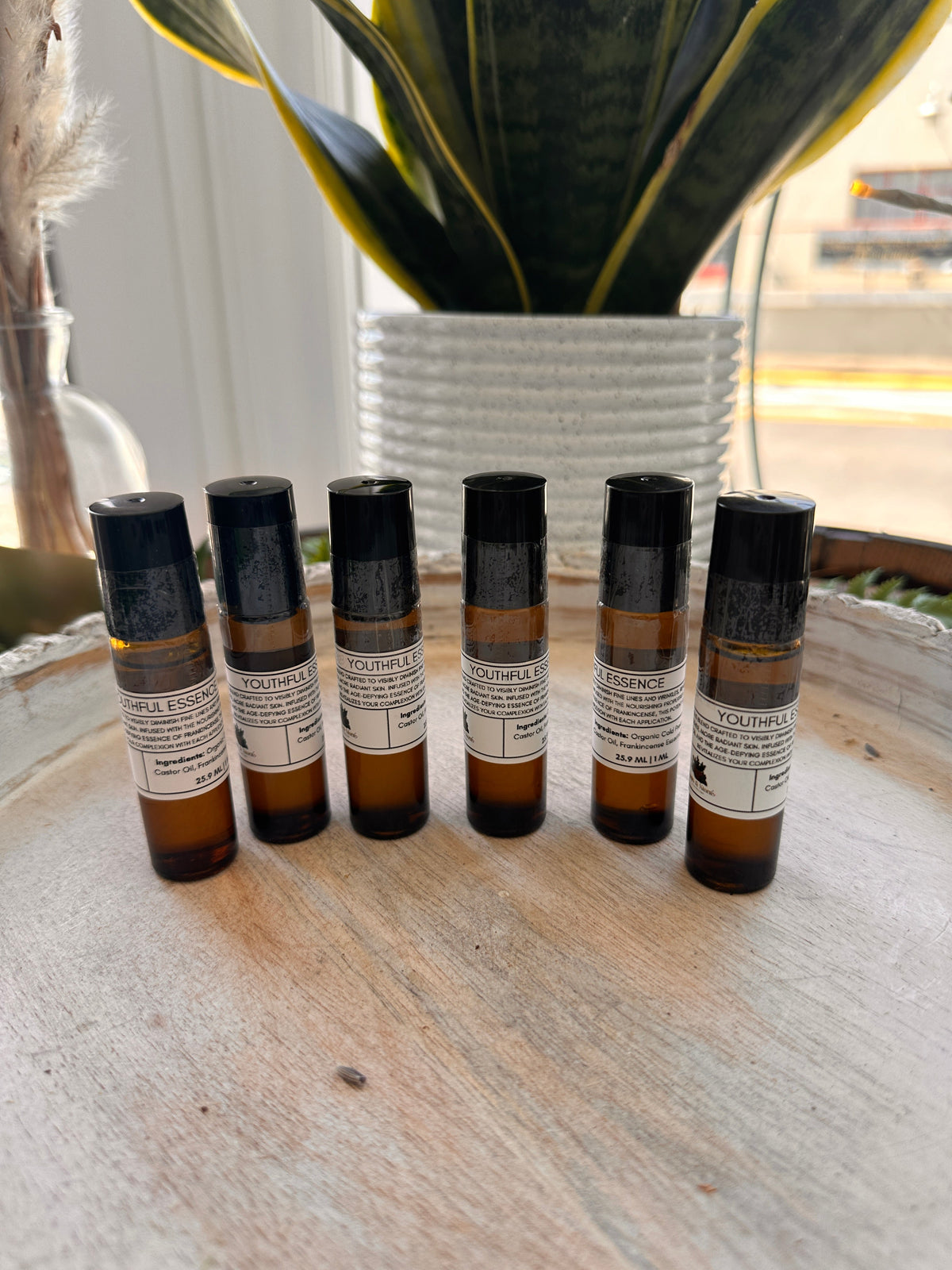 Sage & Stone Apothecary Youthful Essence Roll-On for personal and body care, featuring a clear glass bottle with a rollerball applicator.