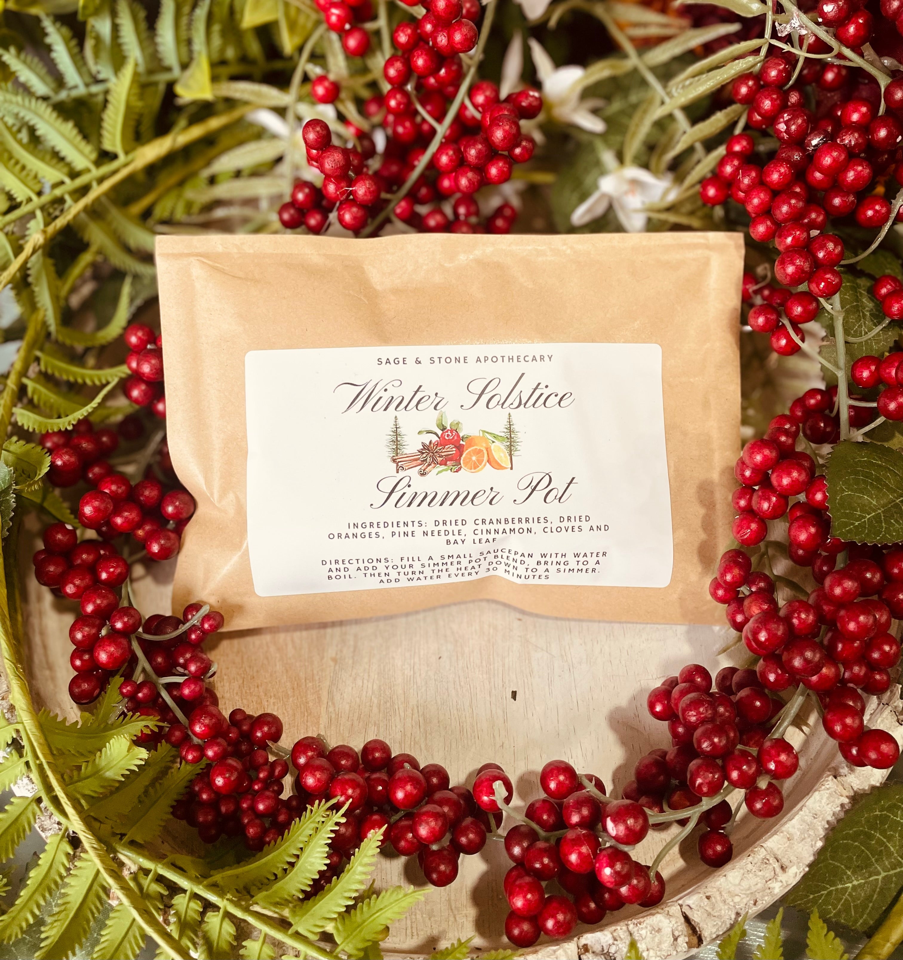 Sage & Stone Apothecary Winter Solstice Simmer Pot with festive herbs and botanicals in a glass simmer pot for seasonal aromatherapy.