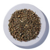 Herbal fertility tea in a cup, featuring Sage & Stone Apothecary Fertility Blend with fresh herbs and flowers.