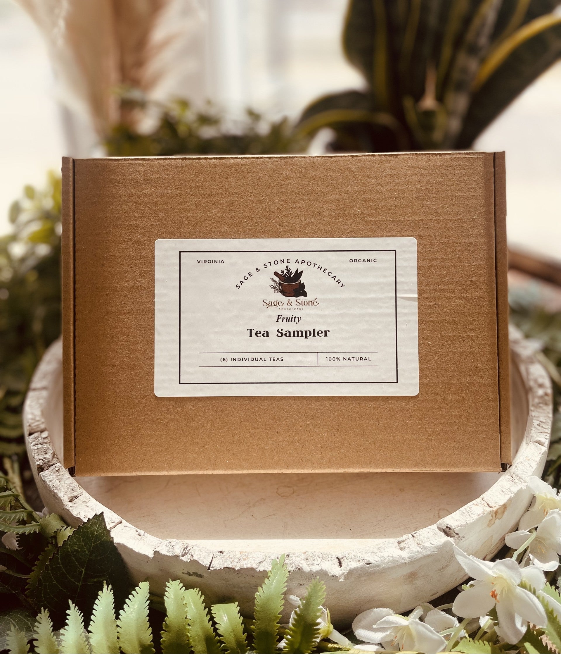 Assorted tea sampler set from Sage & Stone Apothecary featuring various tea and infusion blends in a gift-ready package.