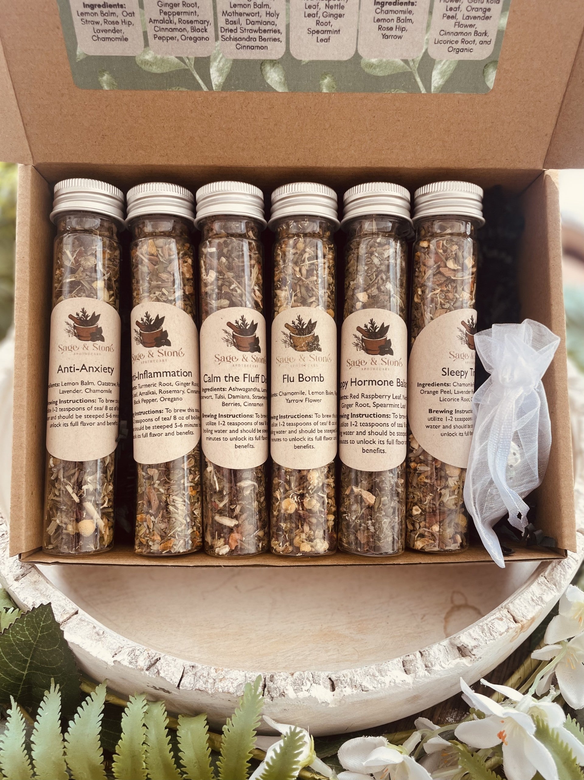 Assorted Sage & Stone Apothecary tea sampler sets with herbal infusions, perfect for gift or kitchen use.