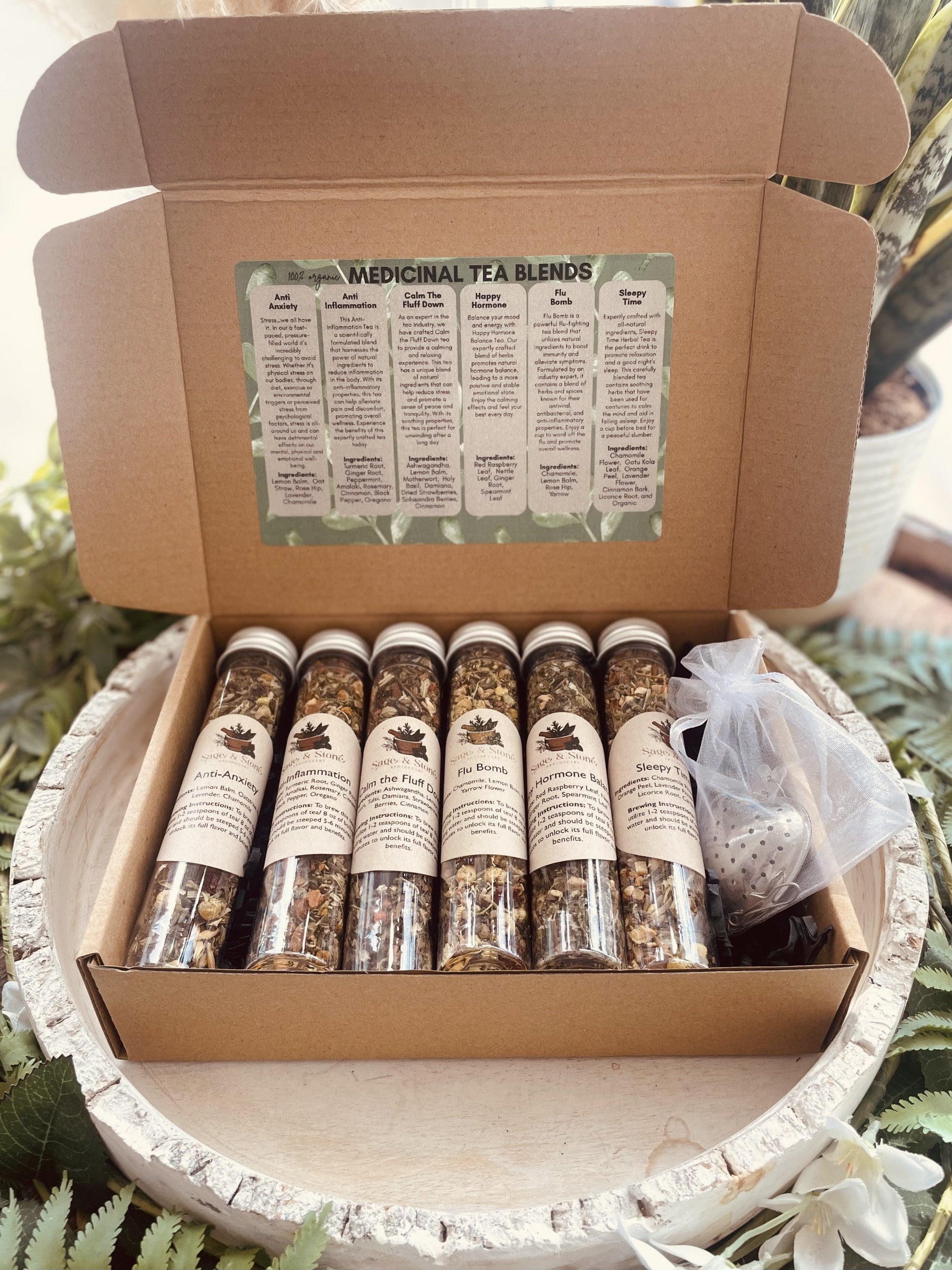 Assorted tea sampler set from Sage & Stone Apothecary featuring herbal infusions and medicinal teas in a decorative box.