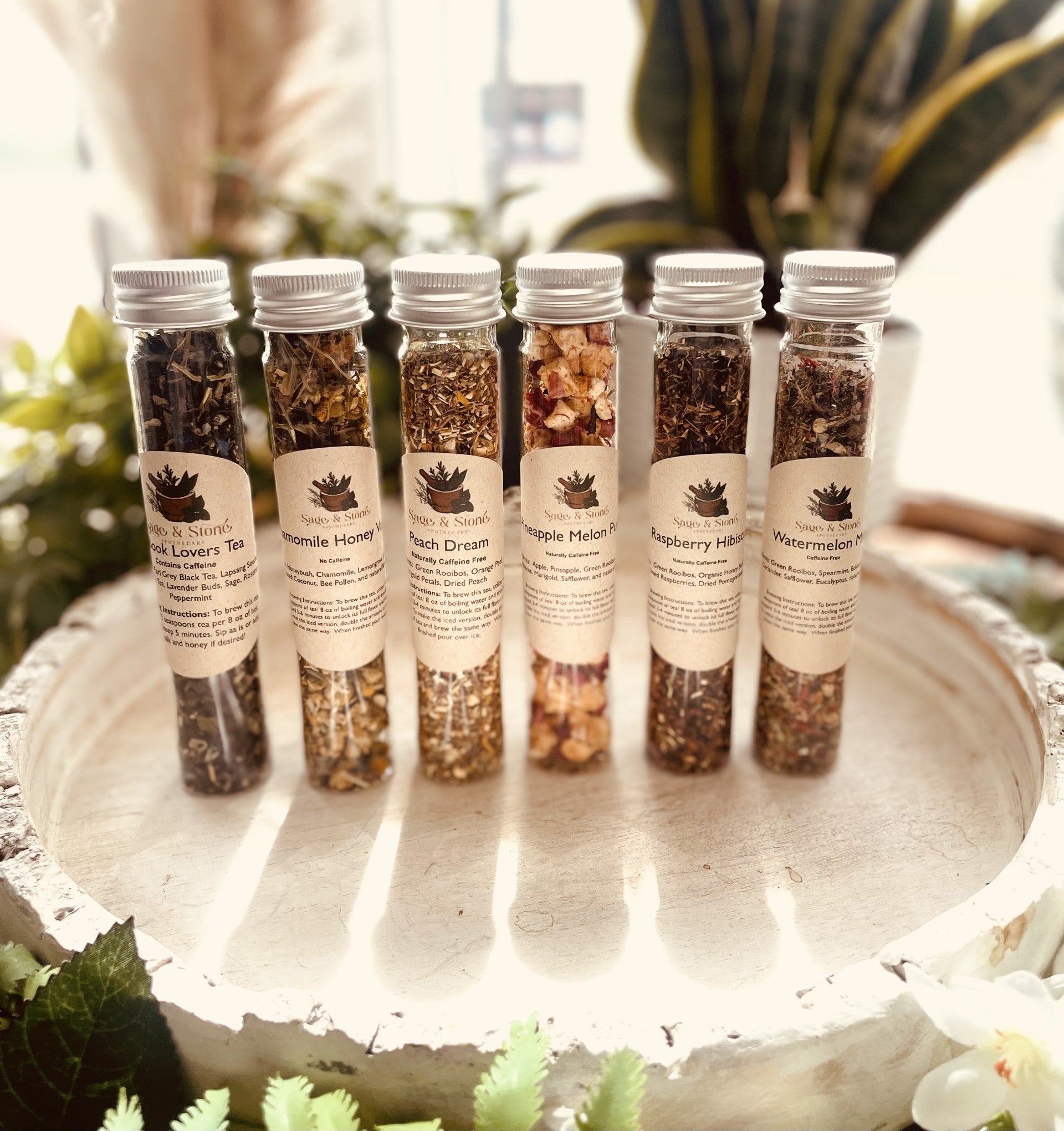 Assorted tea sampler sets with herbal infusions and tea bags from Sage & Stone Apothecary, perfect for gifts and kitchen use.