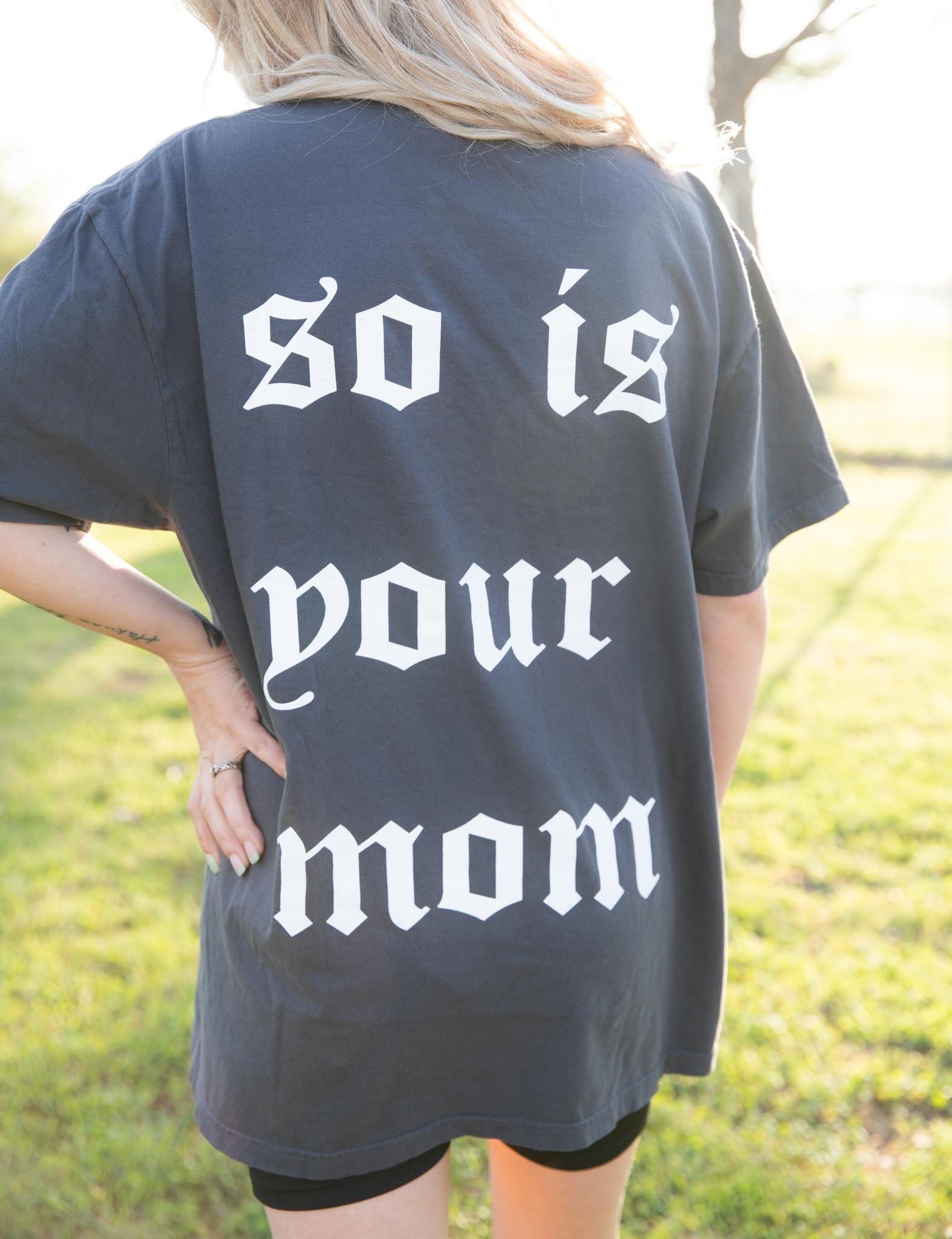 Black graphic T-shirt featuring bold "Tattoos are Trashy" design from Shop Karma Tees, displayed flat on a surface.