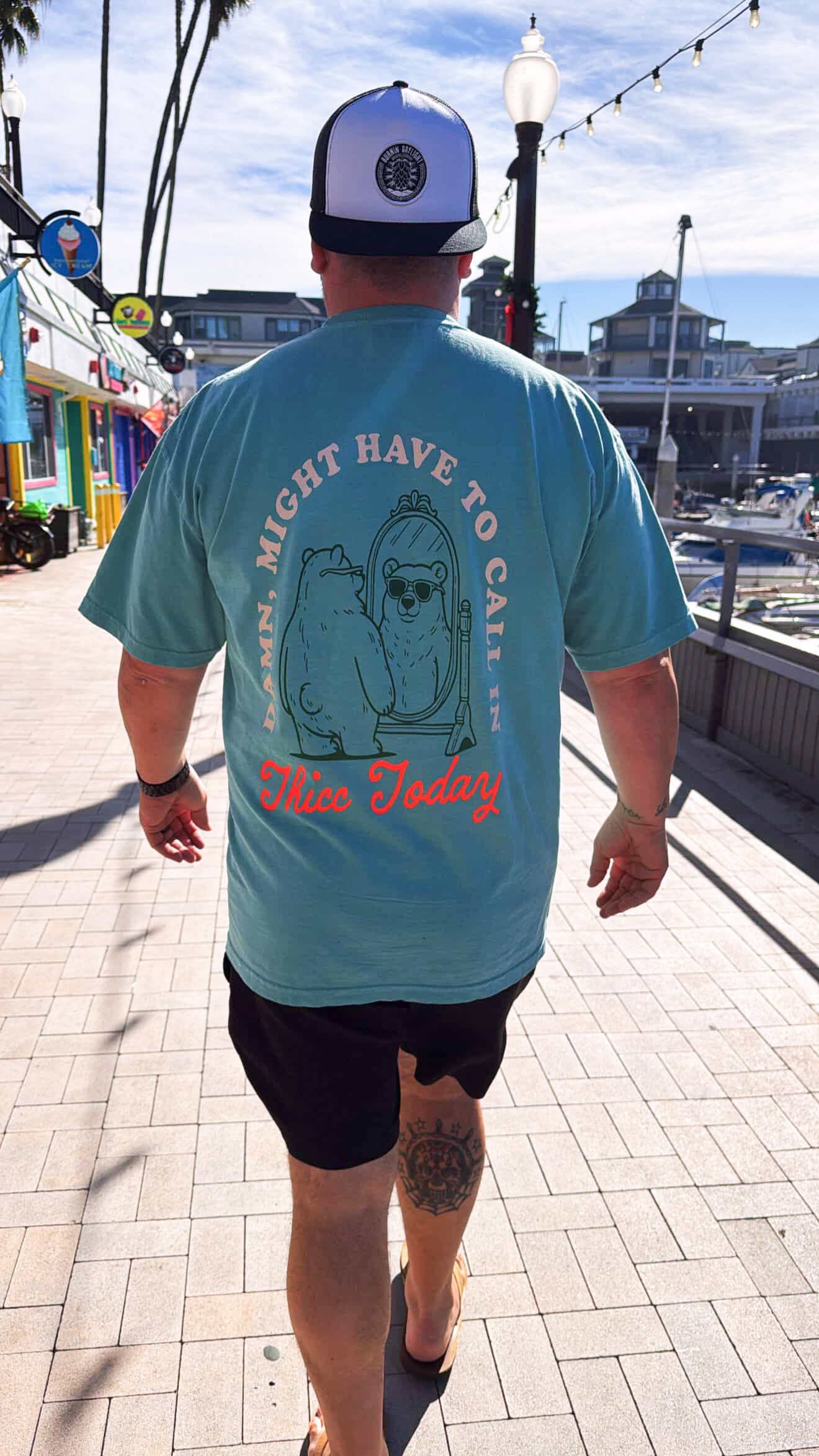 Calling in Thicc graphic T-shirt by Shop Karma Tees featuring bold text and vibrant design on a casual cotton tee.