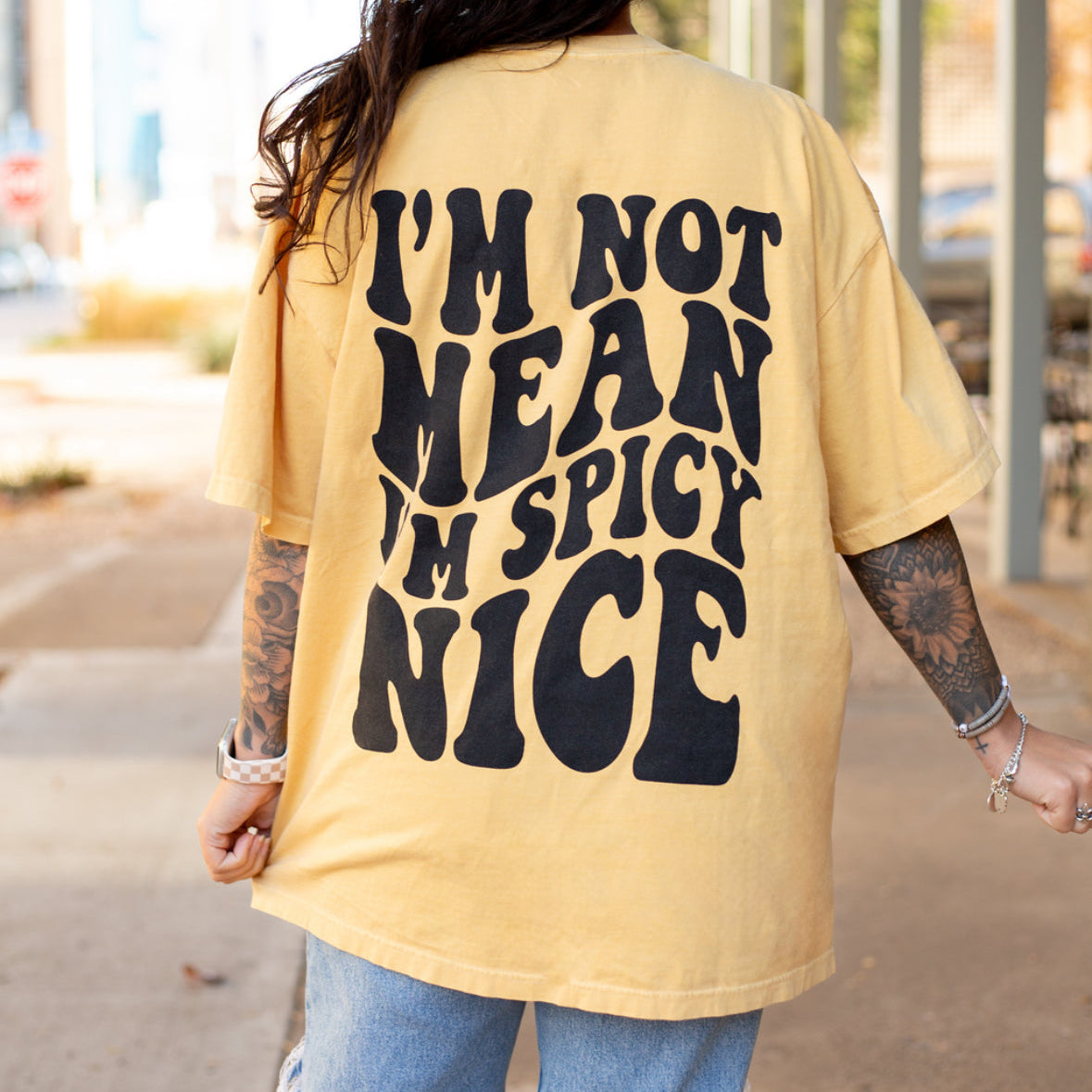 I'm Spicy Nice graphic t-shirt by Shop Karma Tees, featuring bold, colorful "I'm Spicy Nice" text on a casual cotton tee.