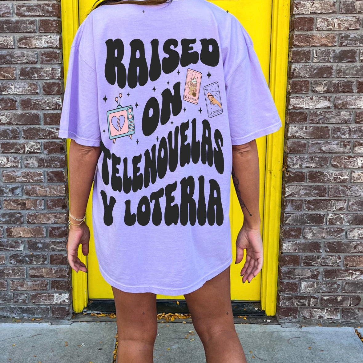 Loteria graphic T-shirt by Shop Karma Tees featuring colorful Loteria card artwork on a casual cotton tee.