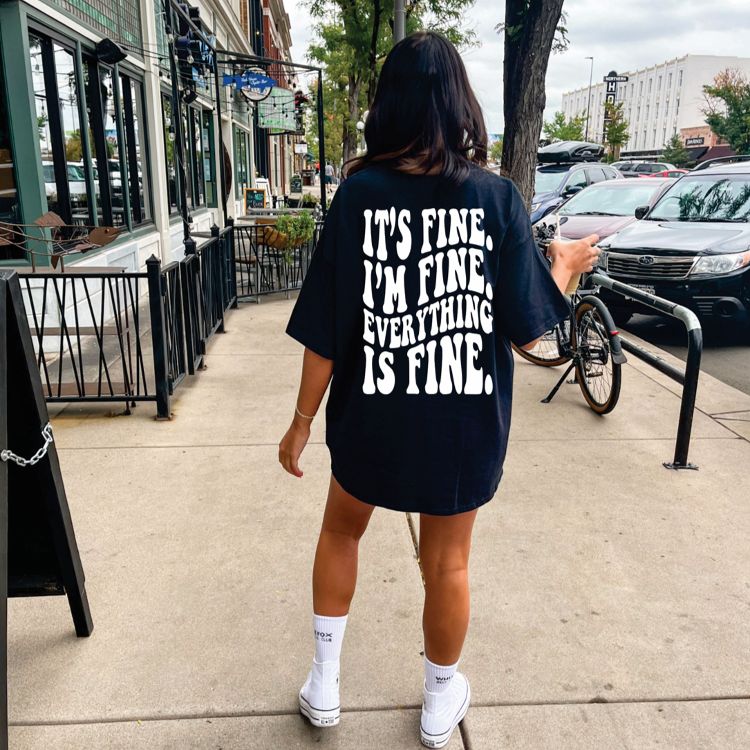 It's Fine graphic tee from Shop Karma Tees featuring a humorous design on a casual cotton shirt.