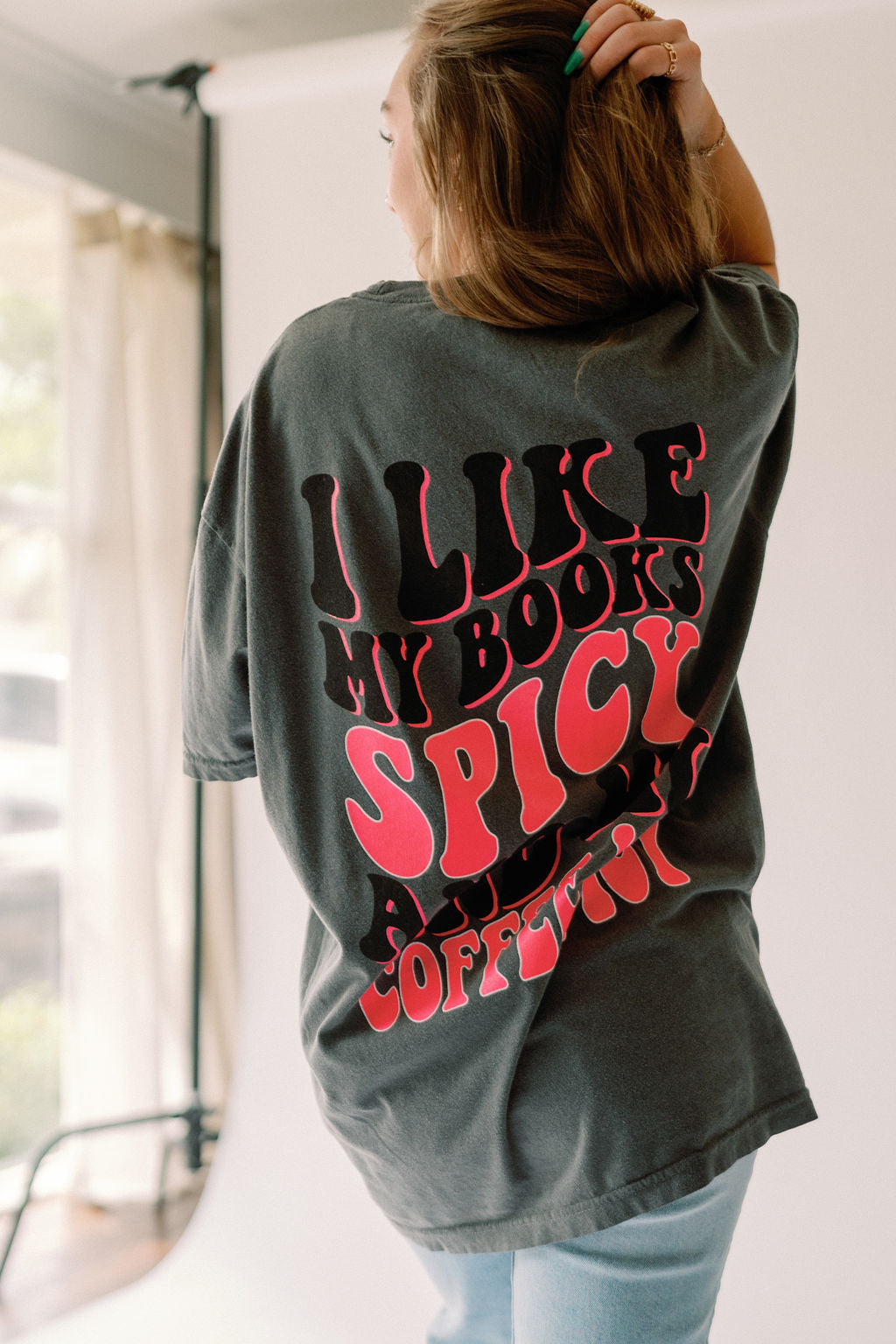 Spicy Books graphic T-shirt by Shop Karma Tees featuring a bold spicy books design in black on a casual tee.