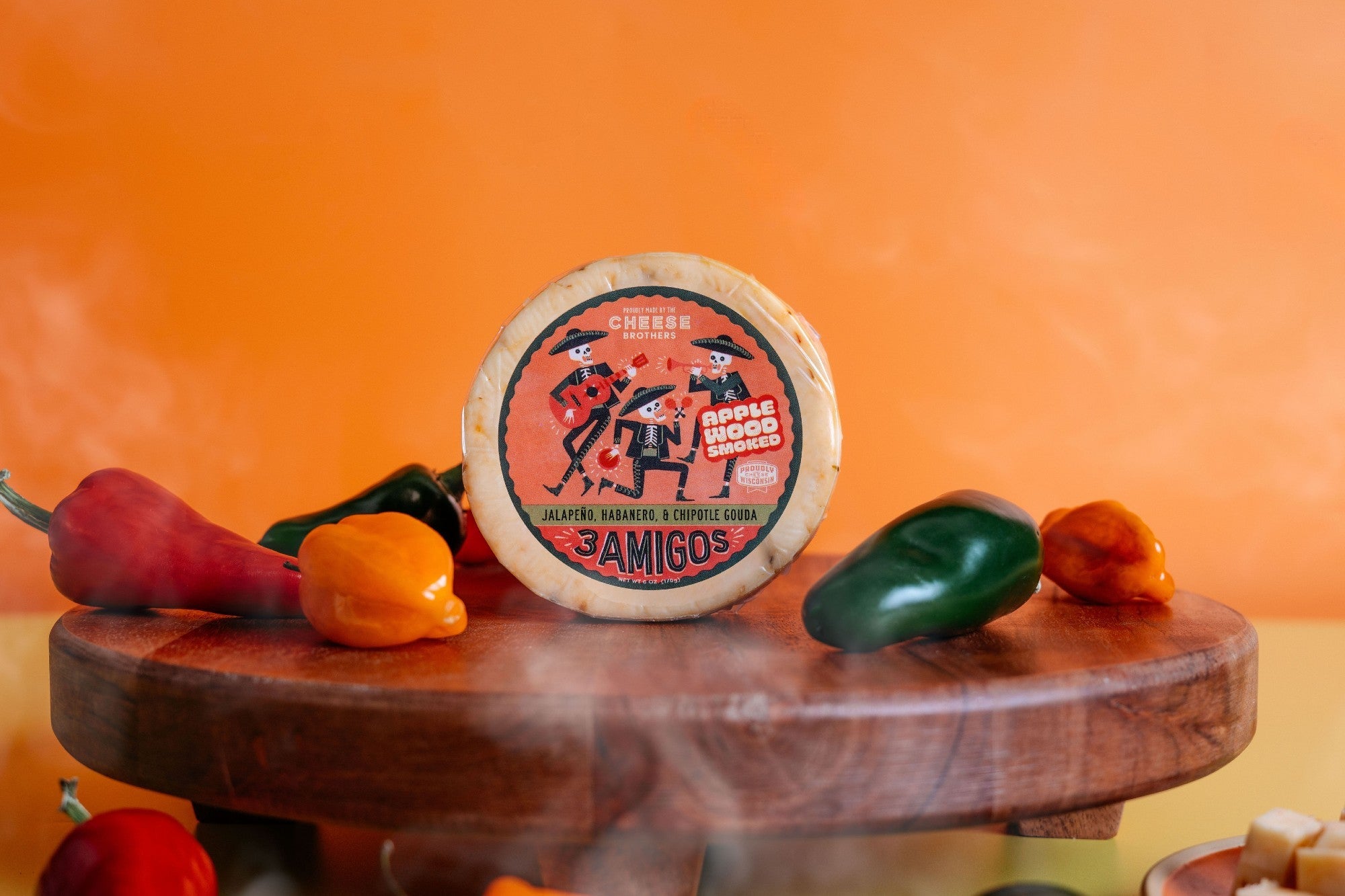 Smoked 3 Amigos spicy Gouda cheese by Cheese Brothers, Inc., showing a block of cheese with smoked and spicy flavor details.