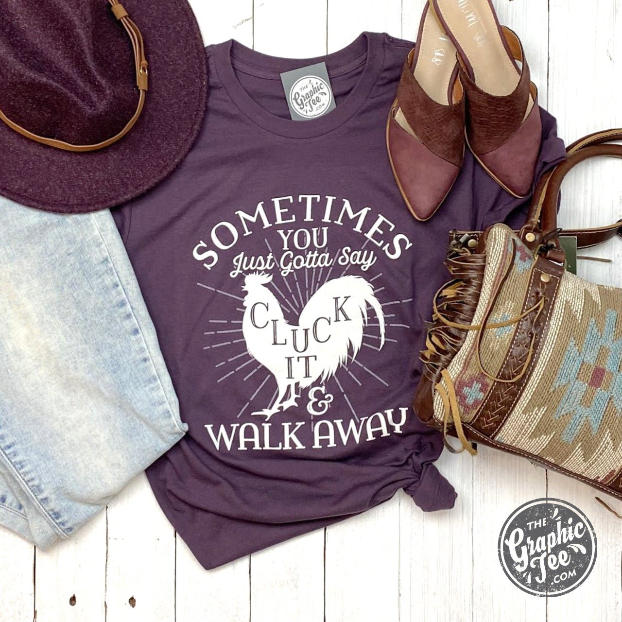 Black SS Graphic Tee by The Graphic Tee featuring humorous "Sometimes You Just Gotta Say Cluck It" slogan in bold lettering.