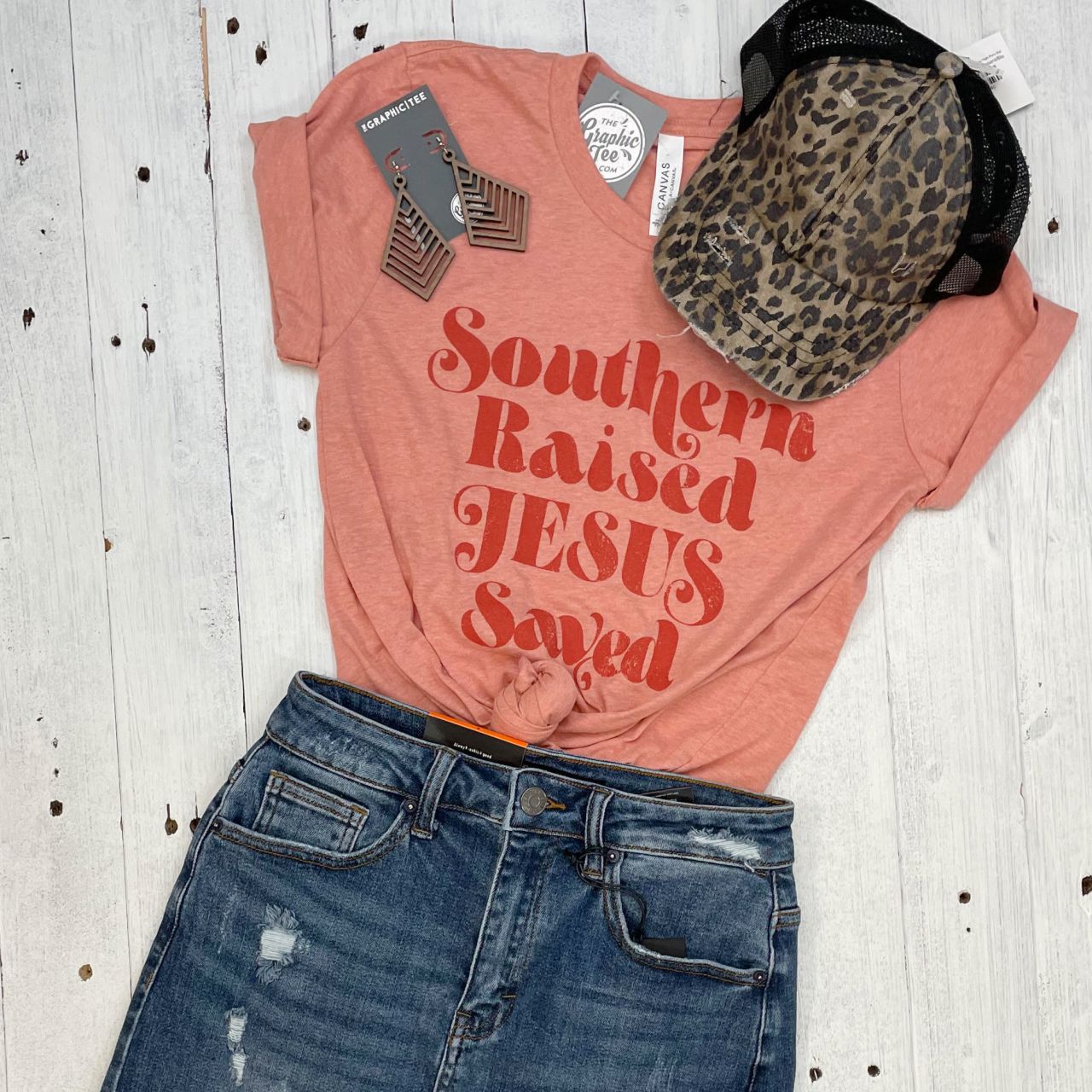 Unisex Southern Raised and Jesus Saved SS Graphic Tee by The Graphic Tee, featuring bold Southern and religious design.