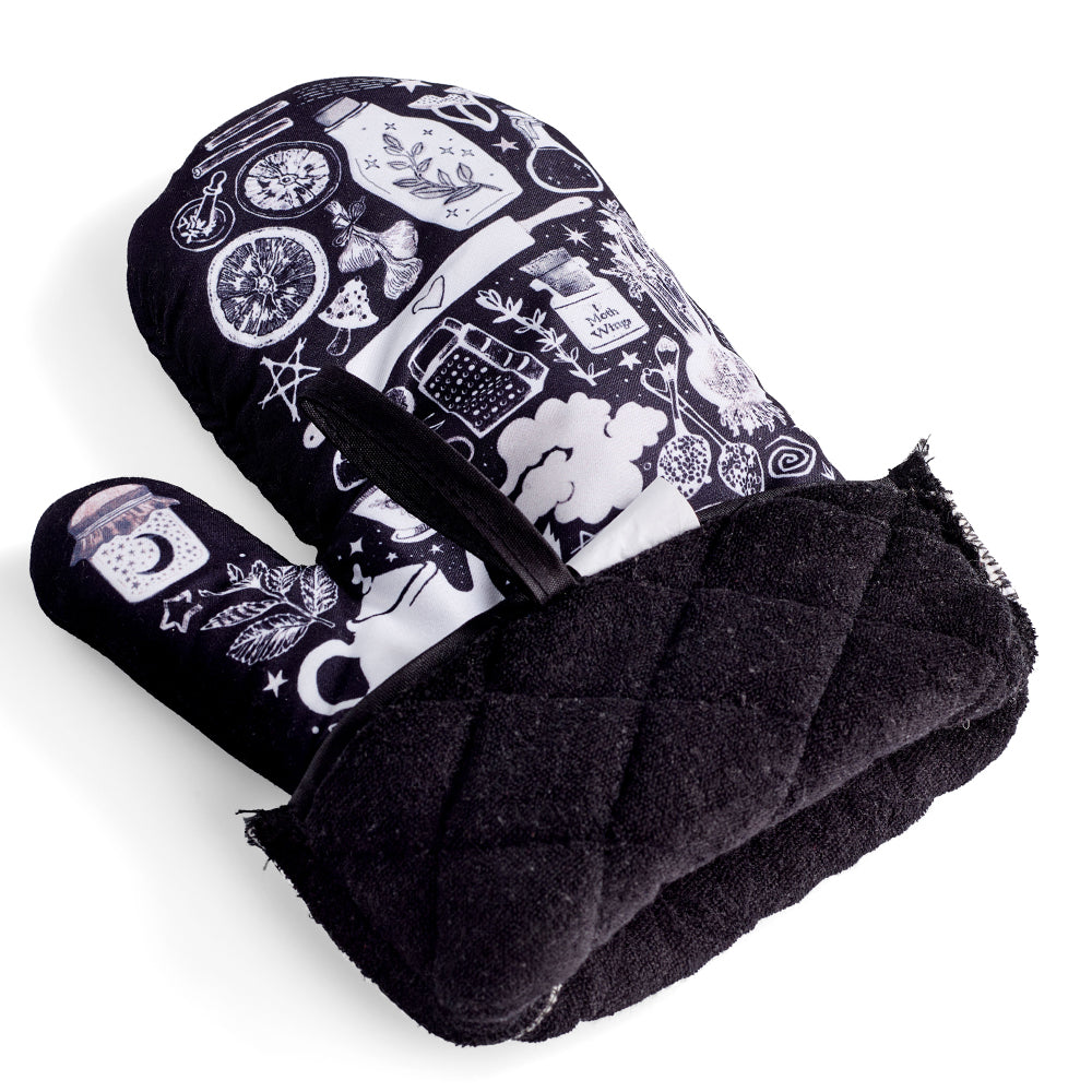 Purple and black kitchen oven mitts featuring witch and herbal designs from the Spirit Nest Kitchen Witch Oven Mitt Set.