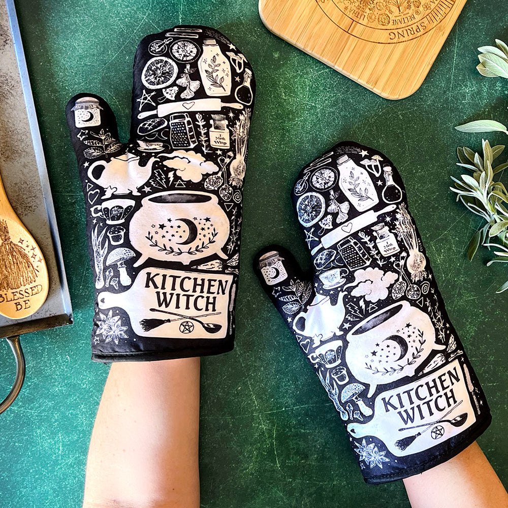 Spirit Nest Kitchen Witch oven mitt set with purple, black, and white herbal witch designs, perfect for cooking and baking.