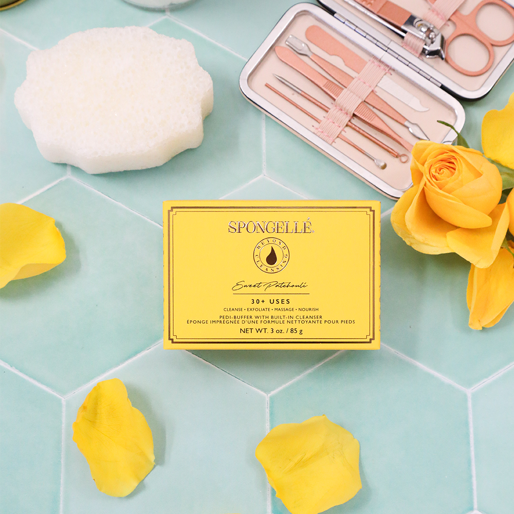 Spongellé Sweet Patchouli Pedi Buffer showing textured surface for exfoliating feet in a close-up image