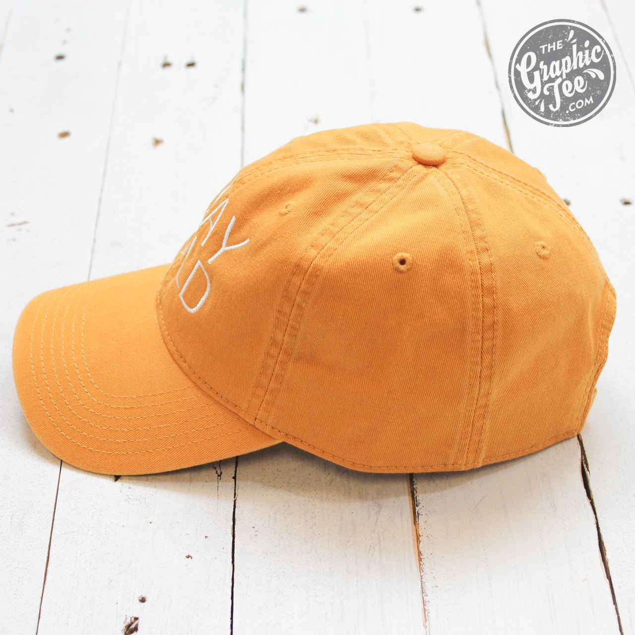 Mustard-colored relaxed twill dad hat with "Stay Wild" embroidered design by The Graphic Tee, casual cap for everyday wear.