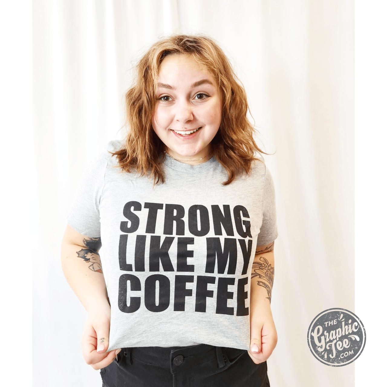 Unisex graphic tee featuring "Strong Like My Coffee" slogan from The Graphic Tee brand, displayed on a casual t-shirt.