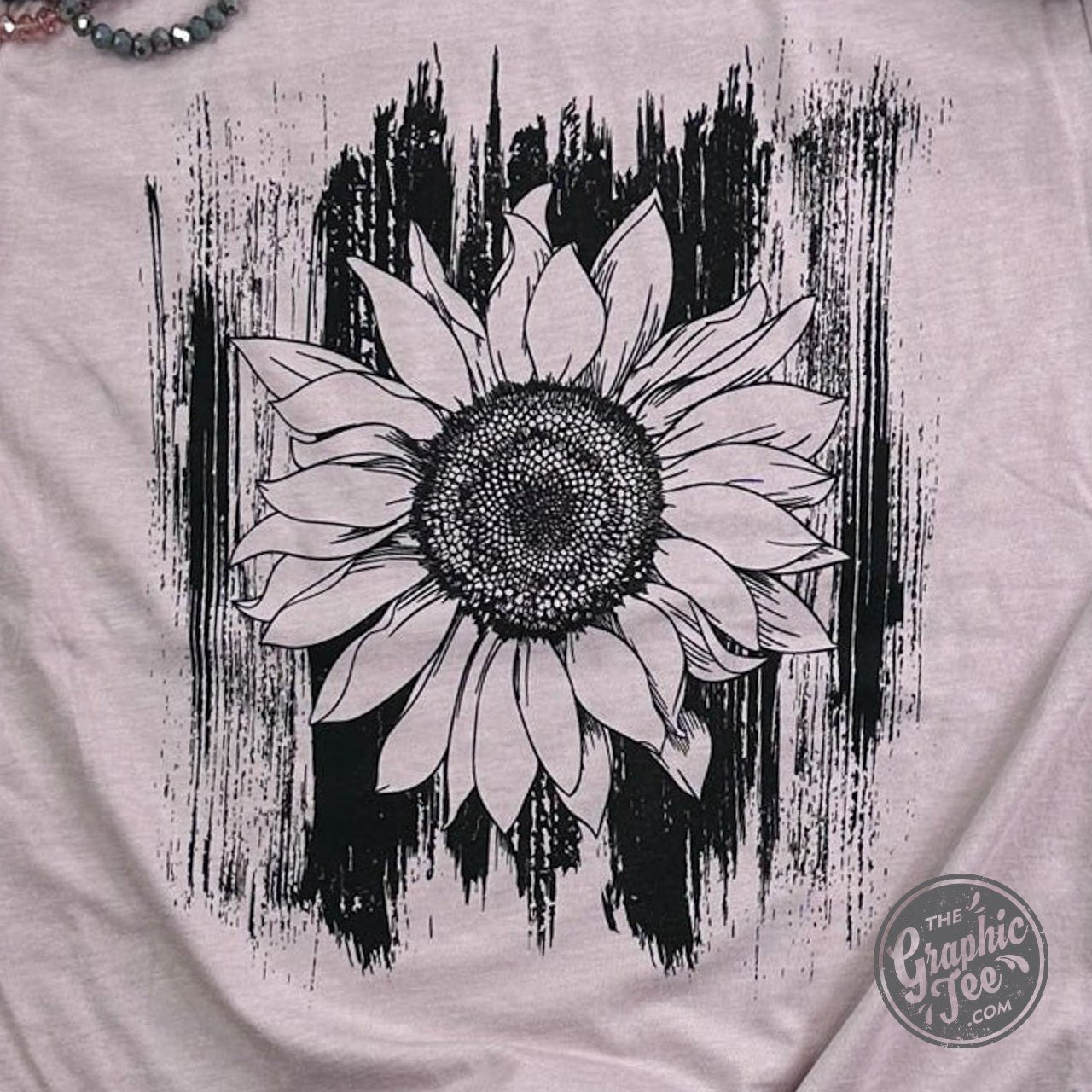 Sunflower with brush strokes on The Graphic Tee SS Graphic Tee crewneck shirt, showcasing vibrant floral artwork.