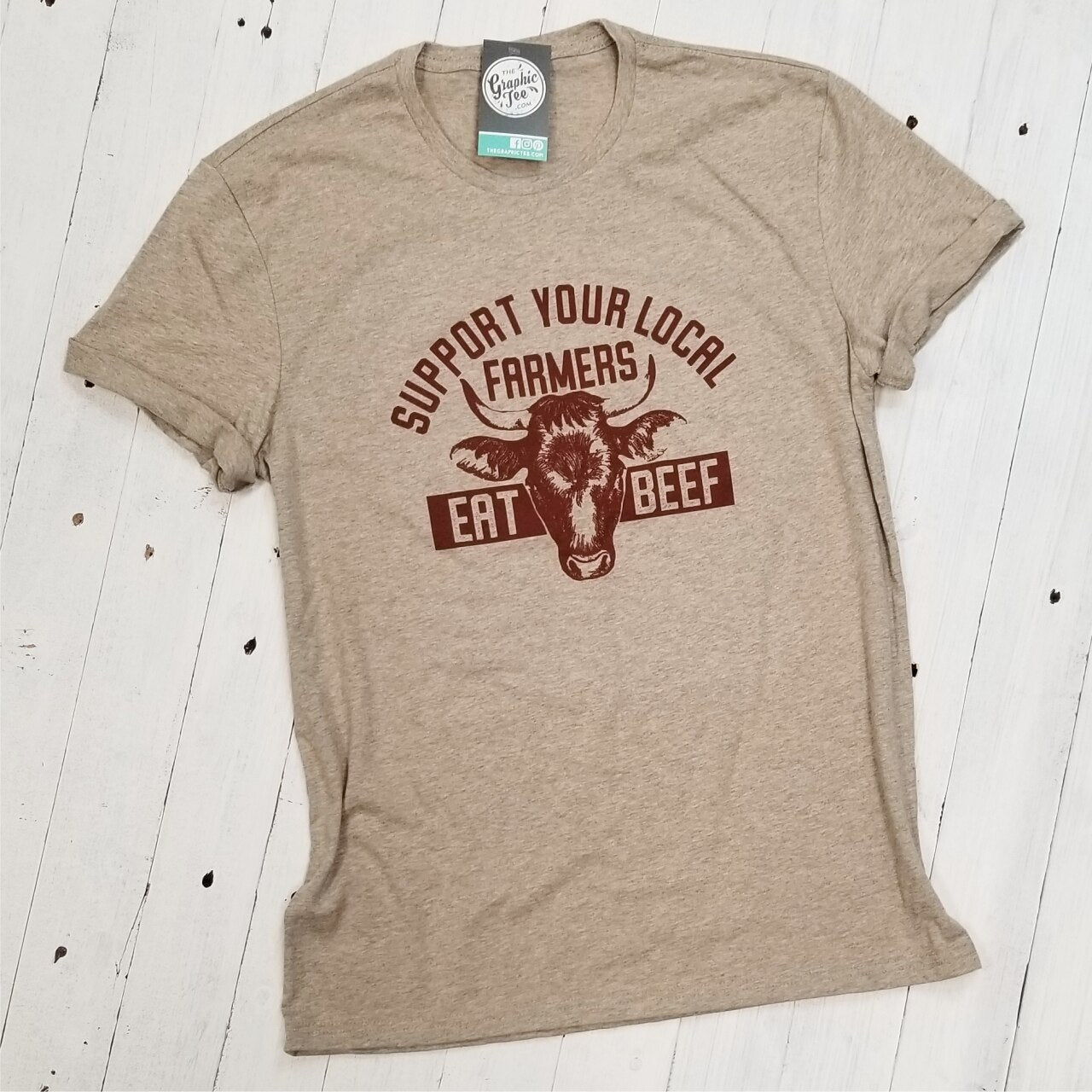 Adult graphic tee by The Graphic Tee supporting local farmers, featuring a colorful "Support Your Local Farmers" design.