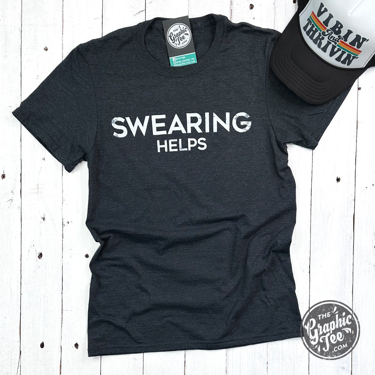 Unisex short sleeve crewneck graphic tee featuring "Swearing Helps" slogan by The Graphic Tee, casual and comfortable t-shirt.