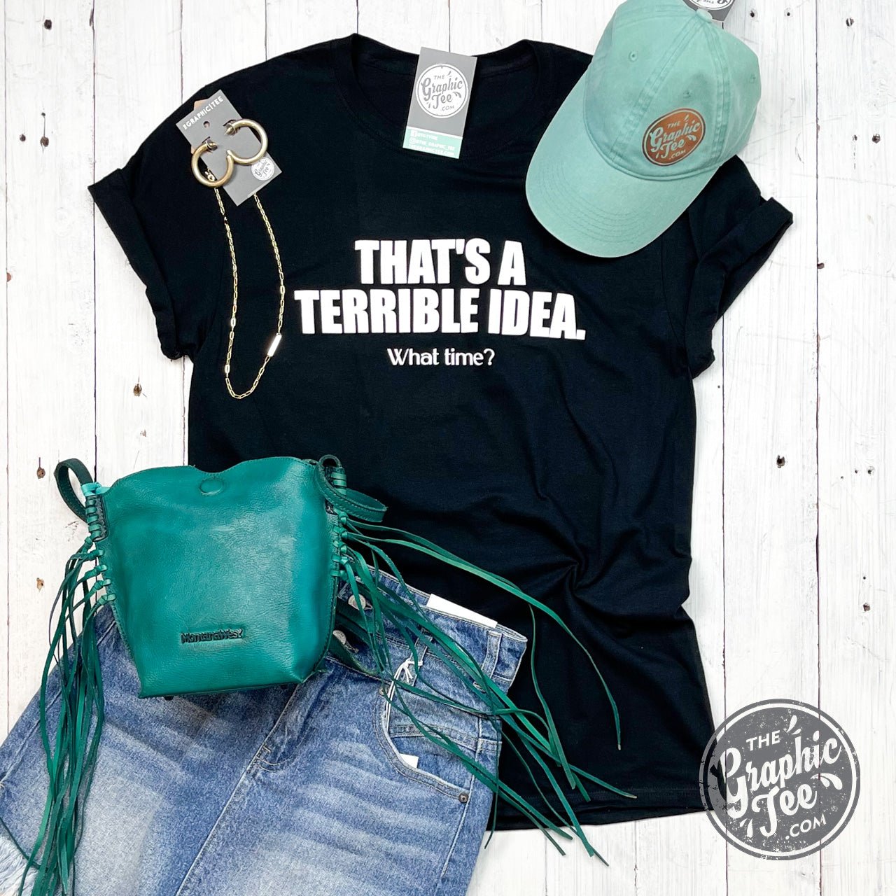 Adult graphic tee by The Graphic Tee featuring the phrase "That's A Terrible Idea What Time?" on a casual short-sleeve t-shirt.