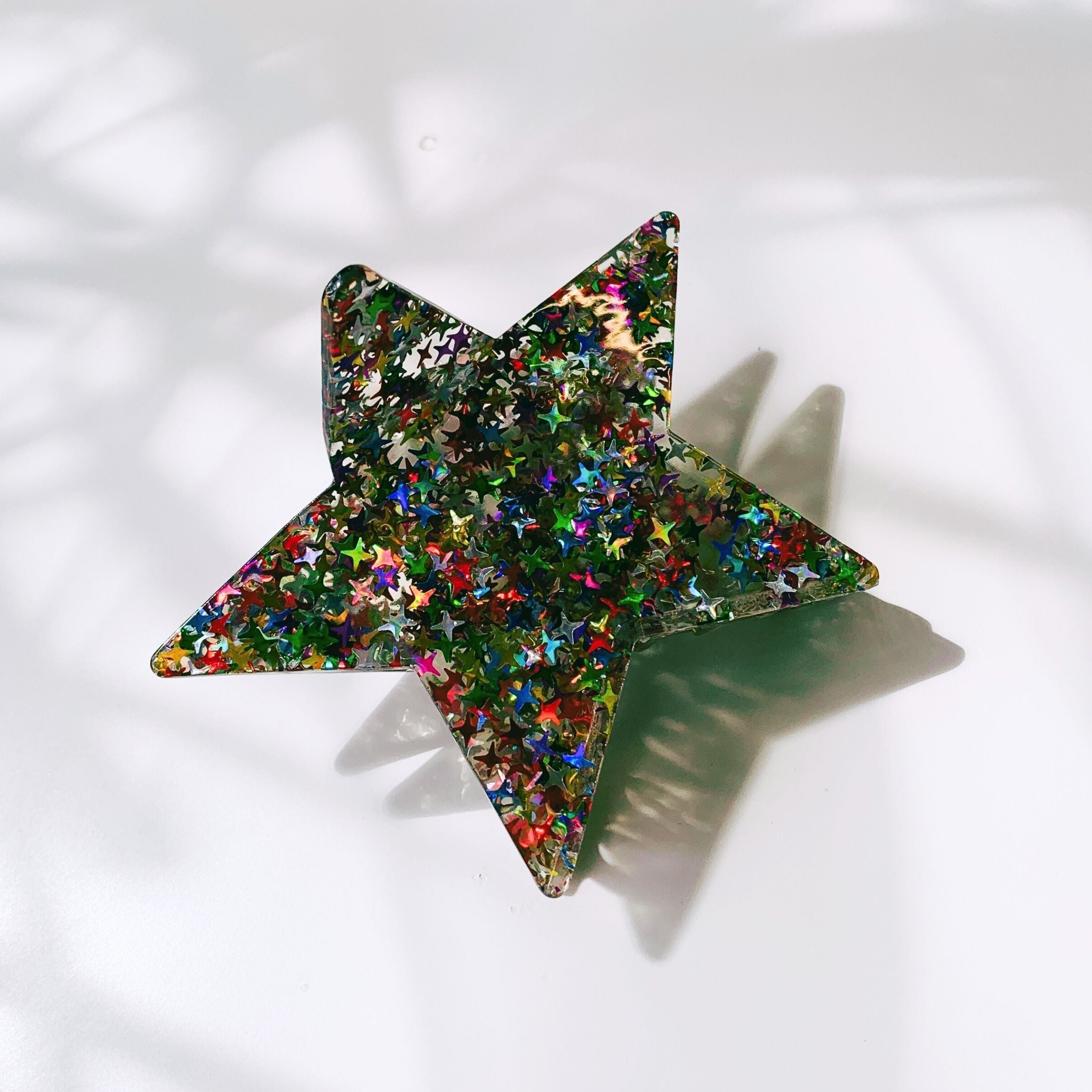 Velvet Claws glitter star hair claw from The Bullish Store, featuring a sparkling star design and velvet finish for stylish accessories.