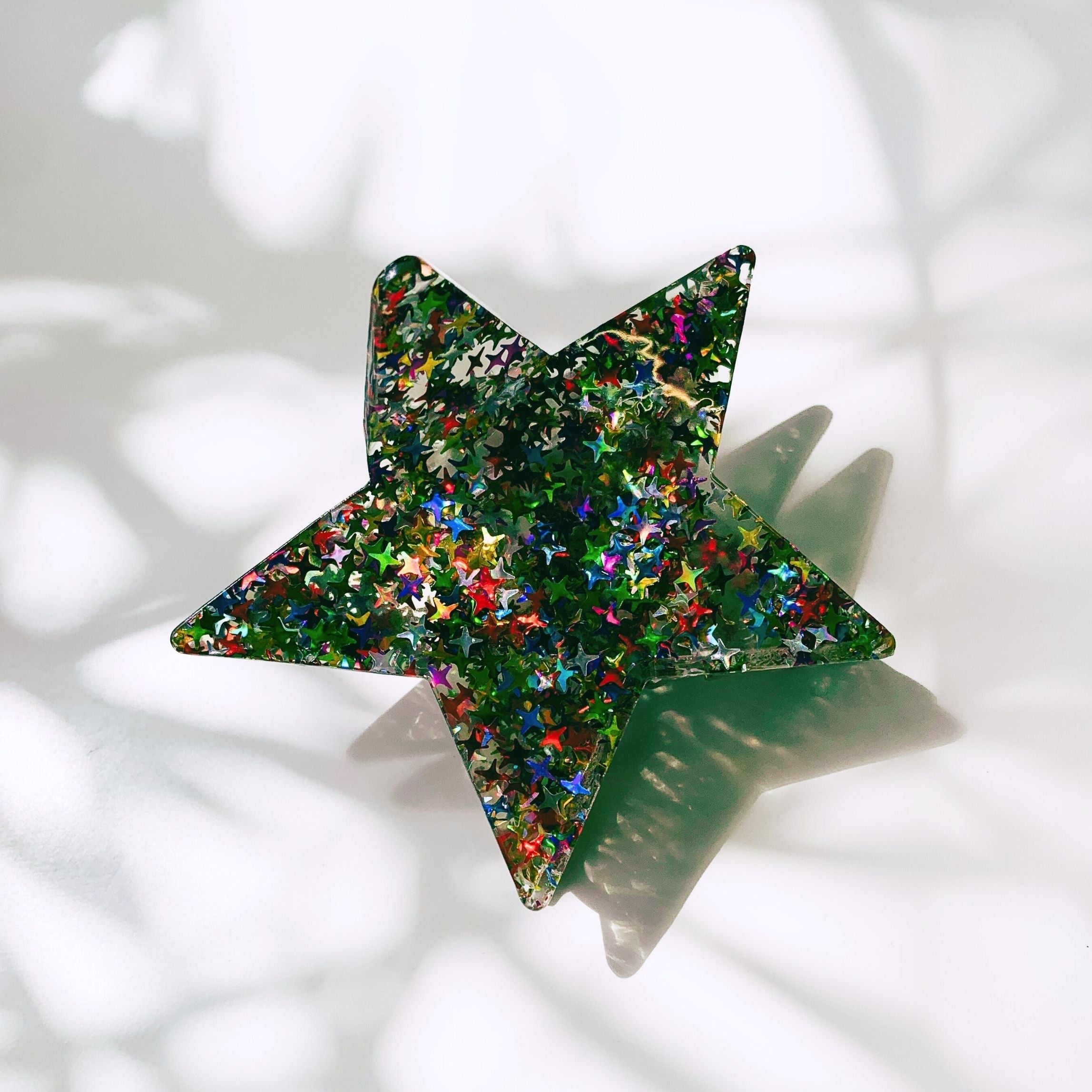 Velvet claw hair clip with glittery star design, stylish accessories from The Bullish Store, perfect for securing hair.