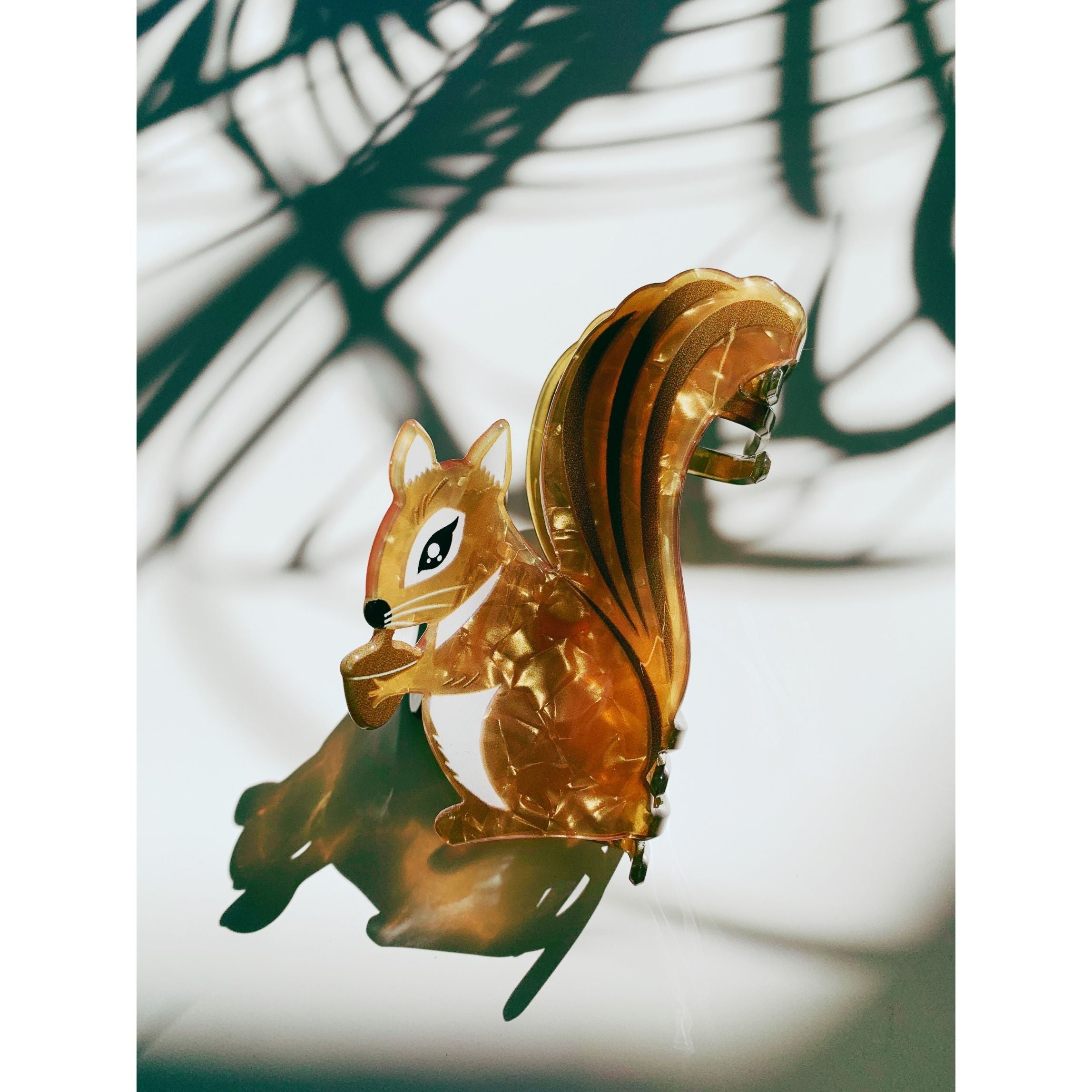 Velvet Claws squirrel hair claw clip holding an acorn, featuring soft velvet material and detailed squirrel design, suitable for hair accessories.