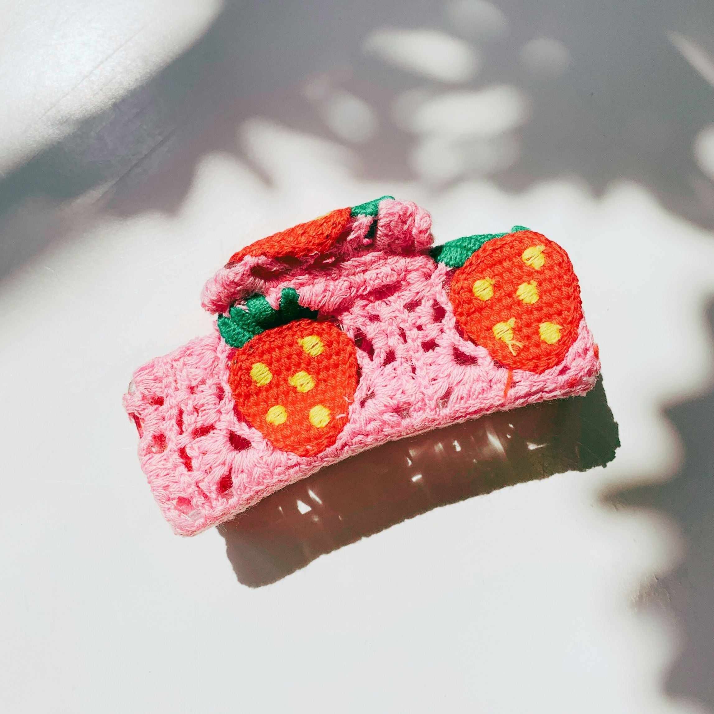 Velvet Claws strawberry granny square hair claw by The Bullish Store, featuring a colorful, textured accessory for hair styling.