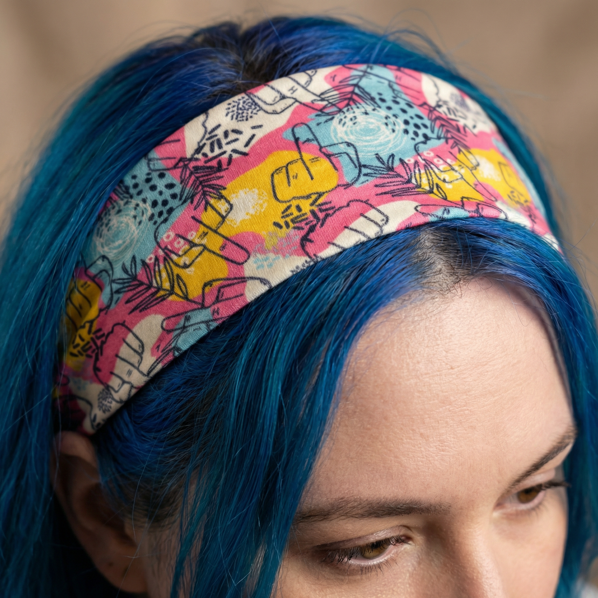 Colorful stretch headband with hidden middle fingers design, fun hair accessory from The Bullish Store featuring bold, humorous style.