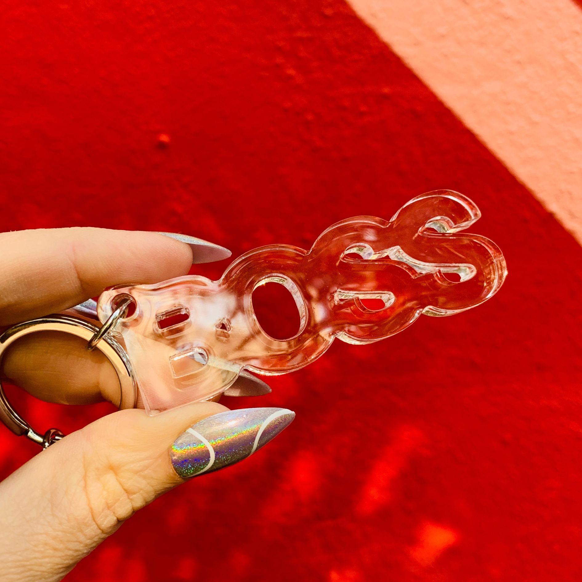 Clear acrylic Boss word keychain from The Bullish Store, transparent and word-shaped keyholder with a sleek design.