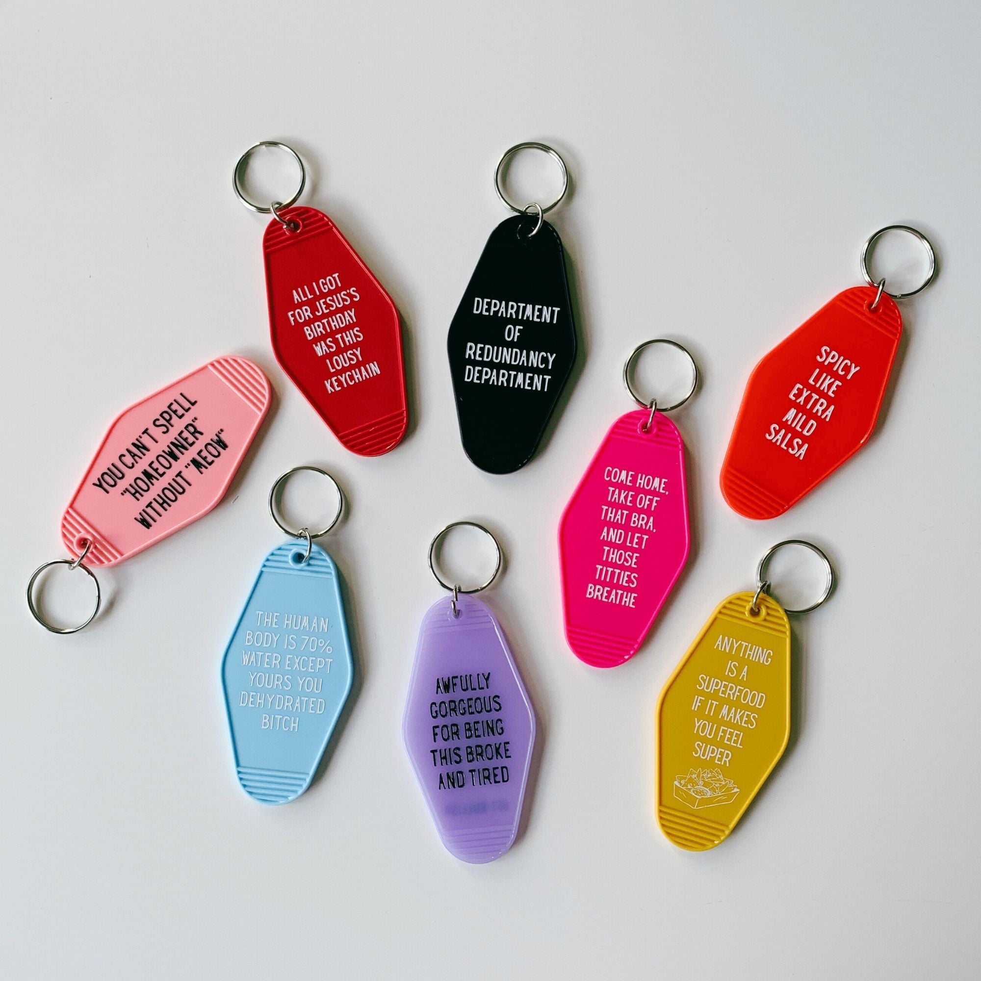 Black Motel Style keychain from the Department of Redundancy Department, featuring humorous motel-themed design.