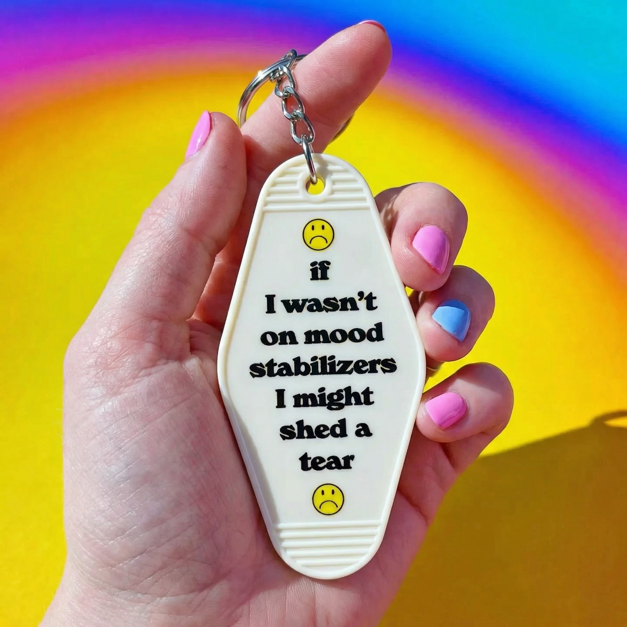 White vintage motel keychain featuring a mood stabilizer design from The Bullish Store, made of durable metal.