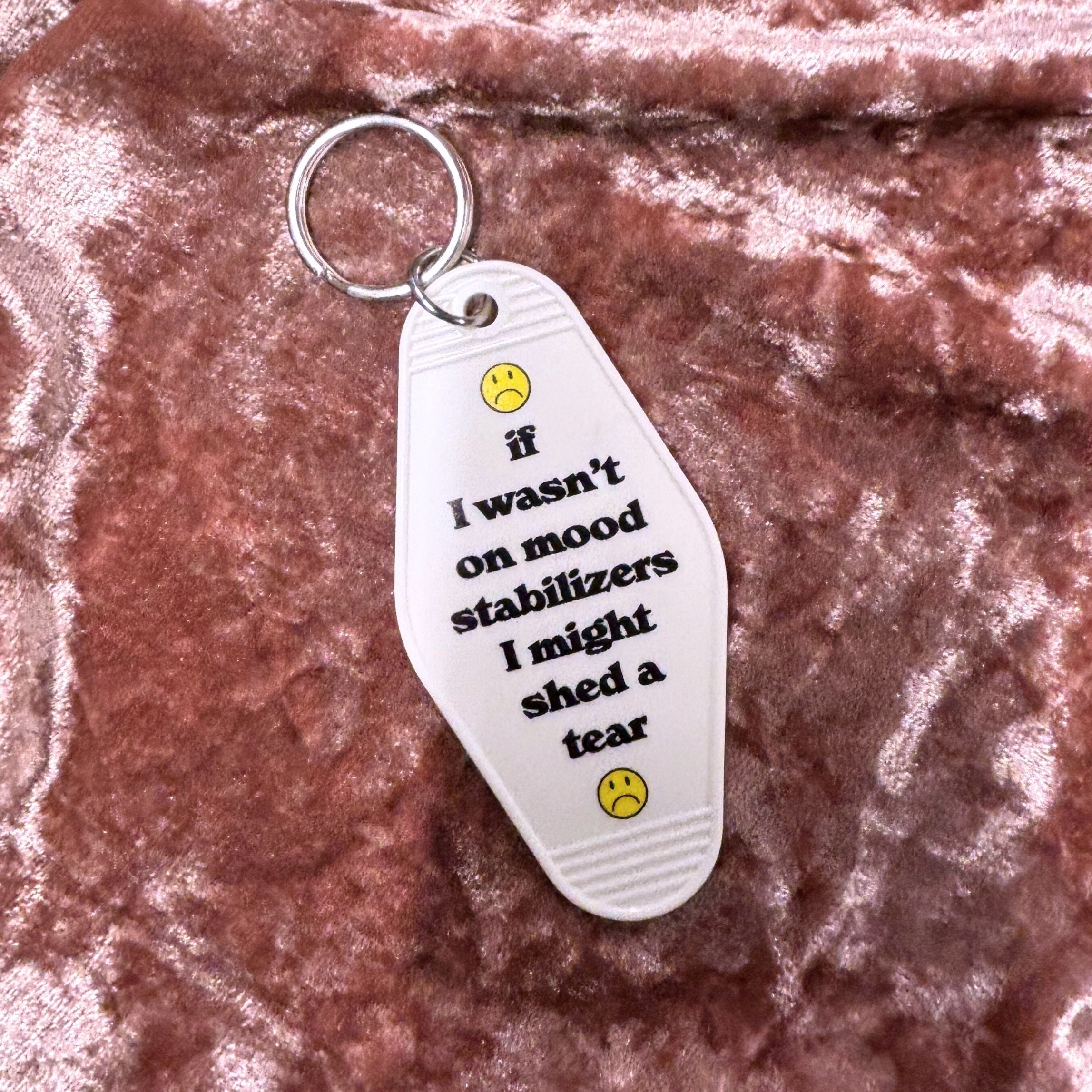 White vintage motel keychain with mood stabilizer design from The Bullish Store, featuring a retro-inspired look.