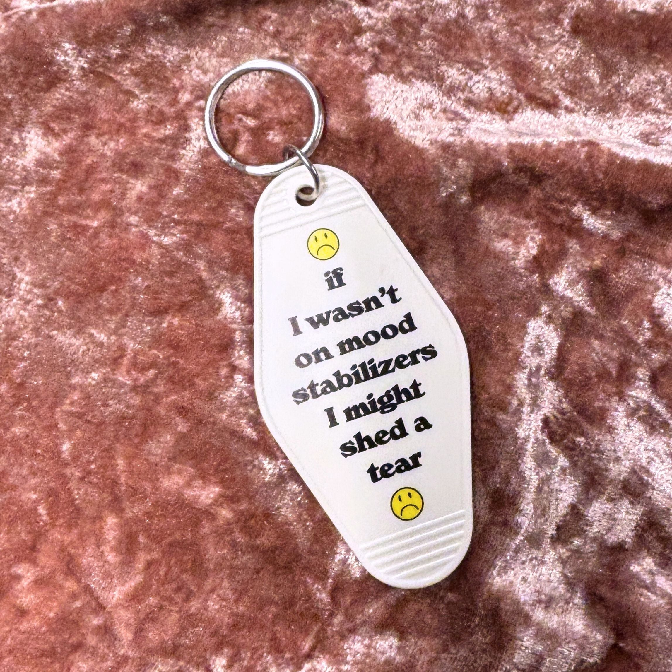 White vintage motel keychain with mood stabilizer design from The Bullish Store, featuring retro style and metal keyring.