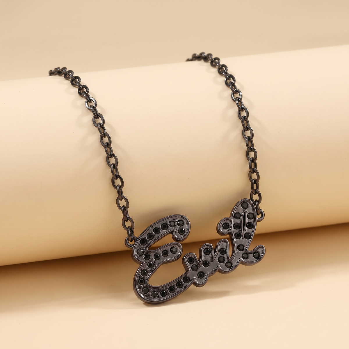 Sourpuss “Evil” pendant necklace with black rhinestones, Gothic statement jewelry featuring an edgy, dark design.
