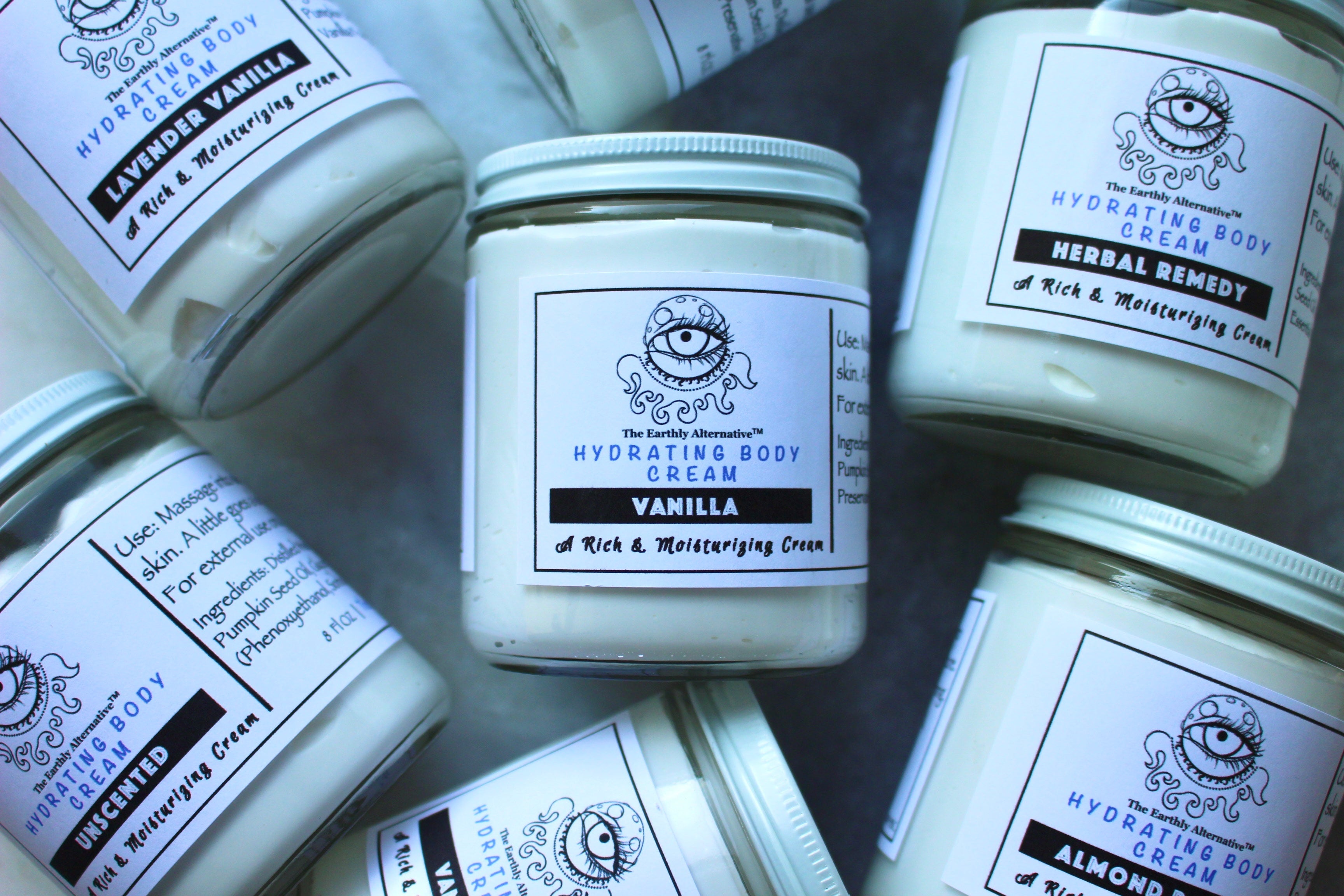 Hydrating body cream from The Earthly Alternative with almond pastry scent, smooth texture, and nourishing formula for dry skin.