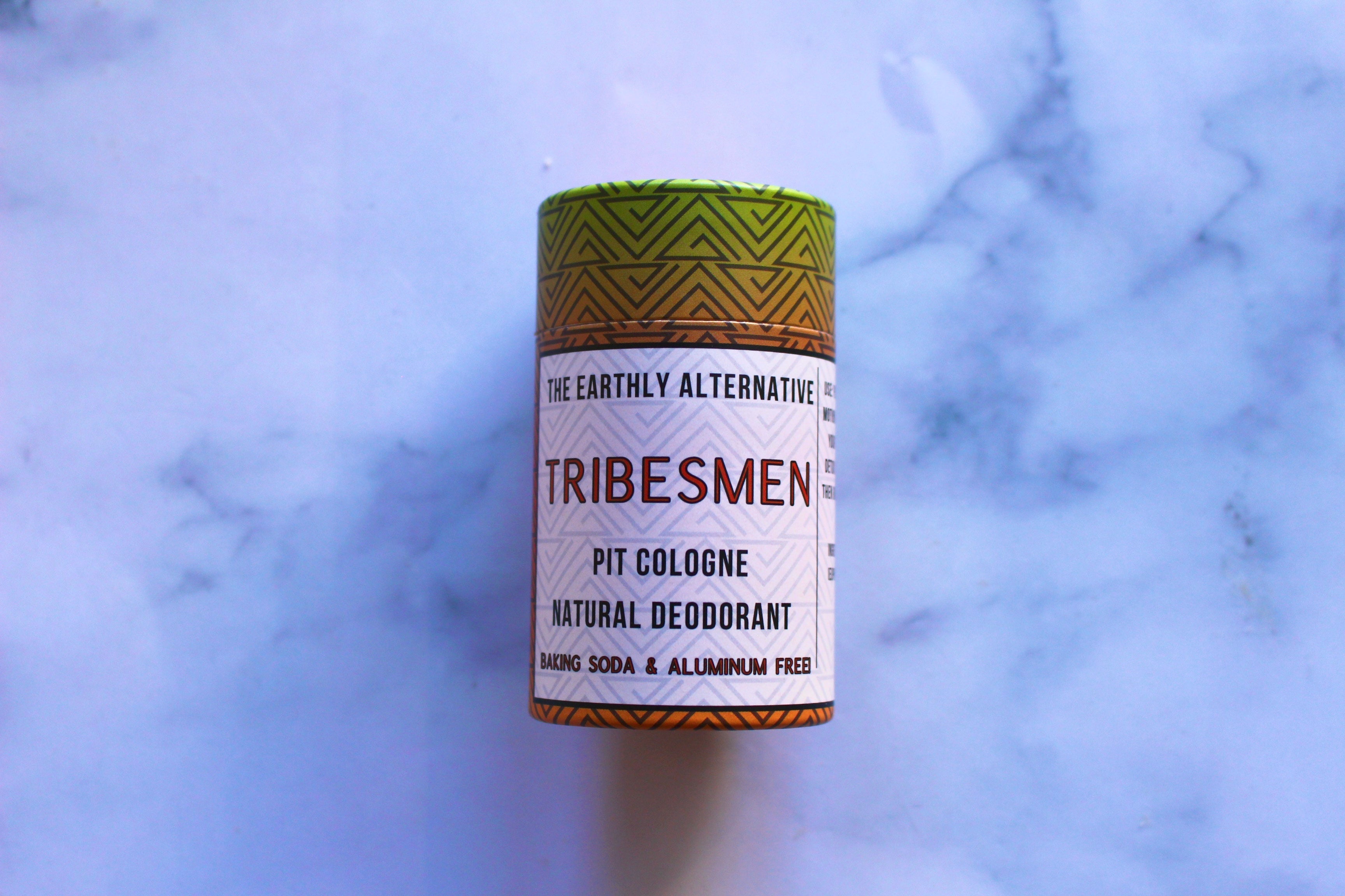 The Earthly Alternative Pit Cologne Deodorant for men, featuring a sleek container with natural ingredients and minimalist design.