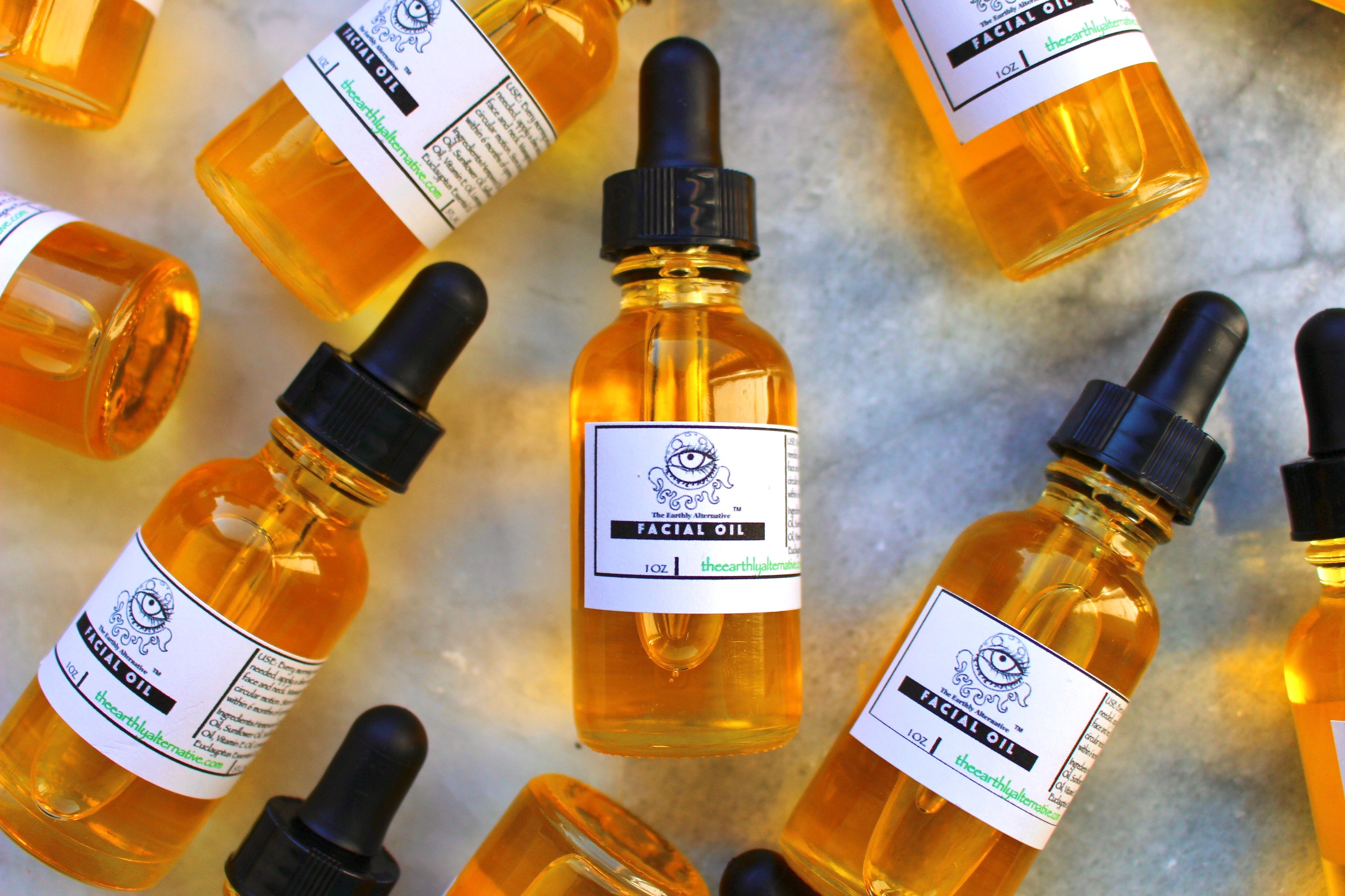 The Earthly Alternative facial oil bottle with dropper, displayed on a neutral background, highlighting natural skincare ingredients.
