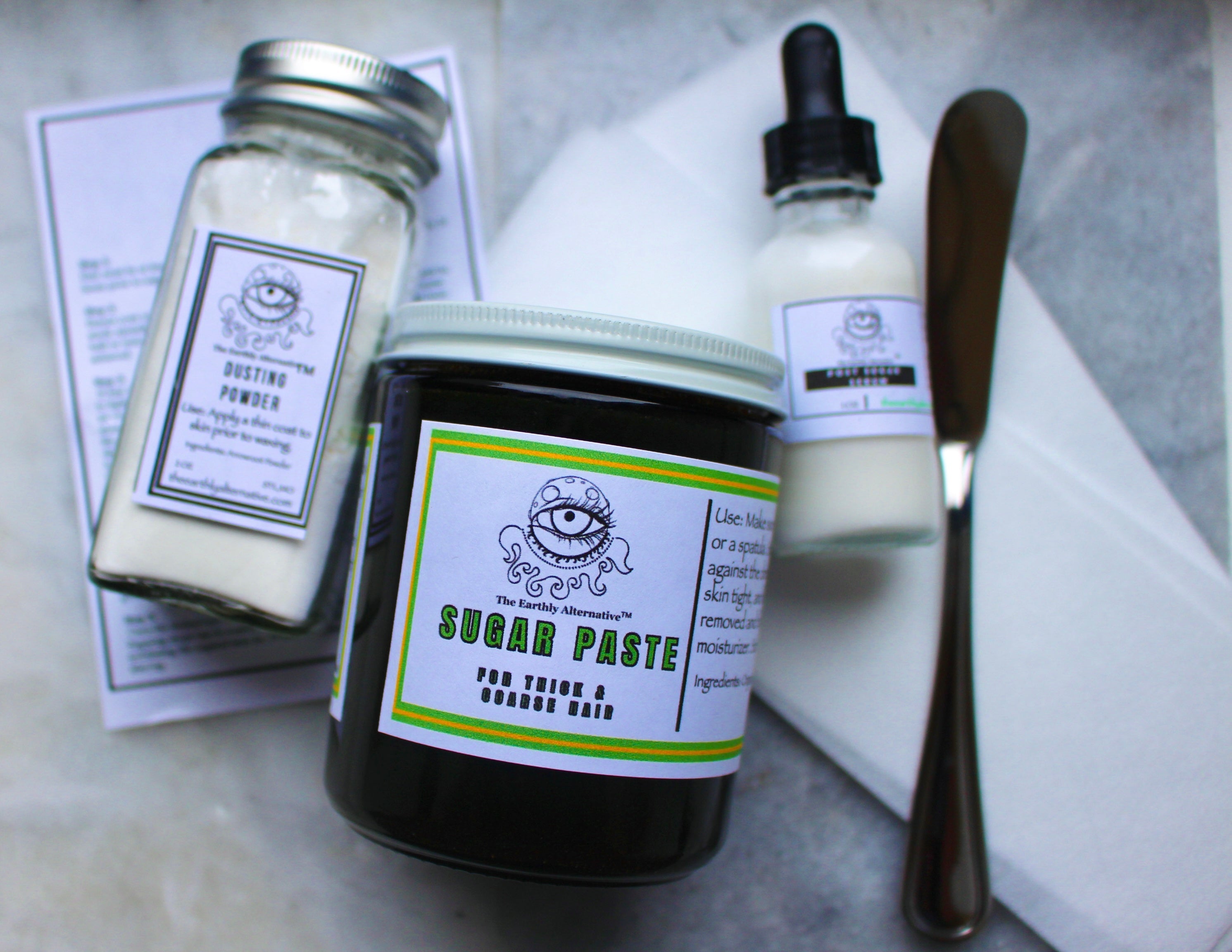 Sugaring Kit from The Earthly Alternative featuring natural hair removal wax, applicators, and instructions for DIY waxing at home.