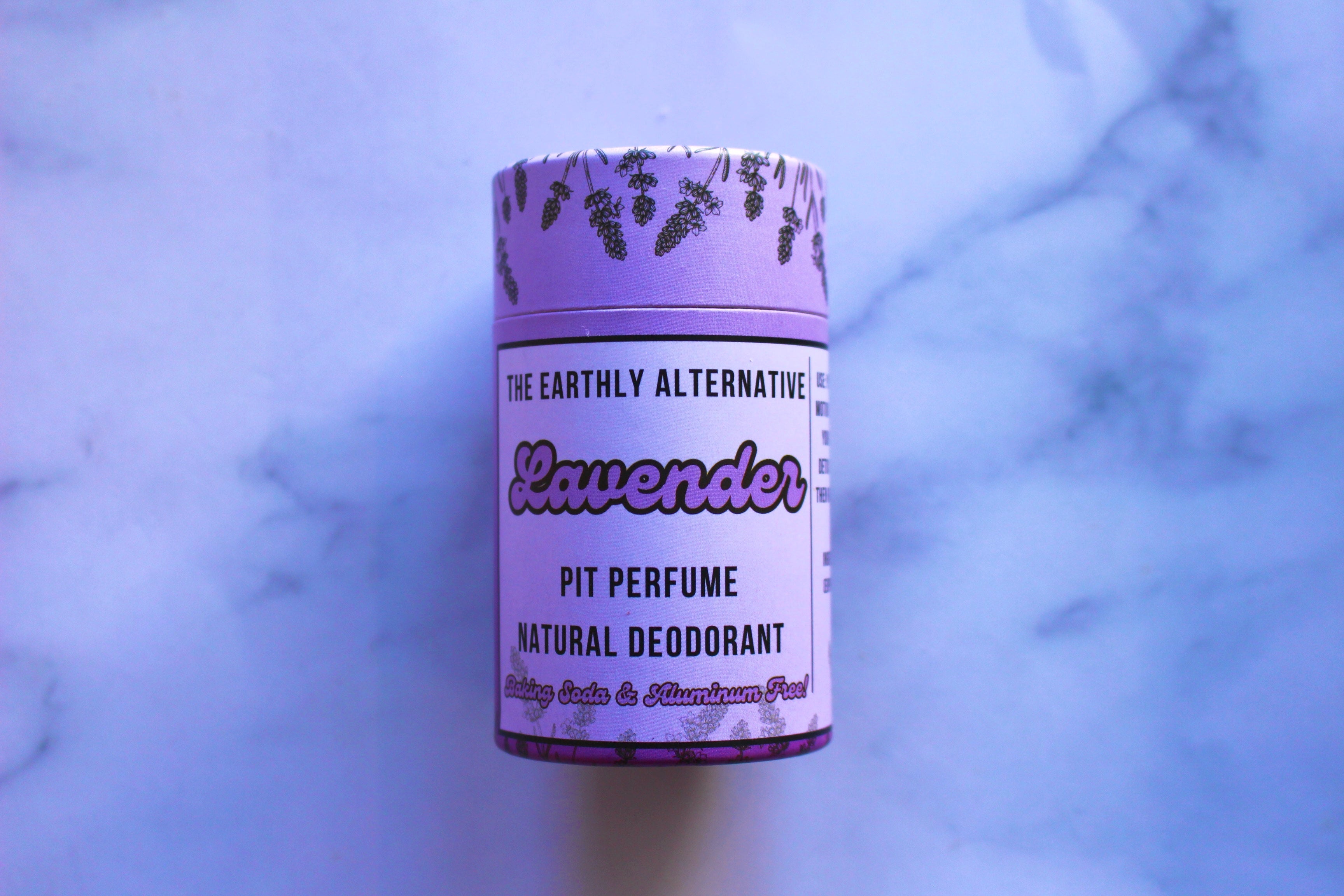 The Earthly Alternative Pit Perfume Deodorant in amber bergamot scent, natural deodorant stick with botanical ingredients.