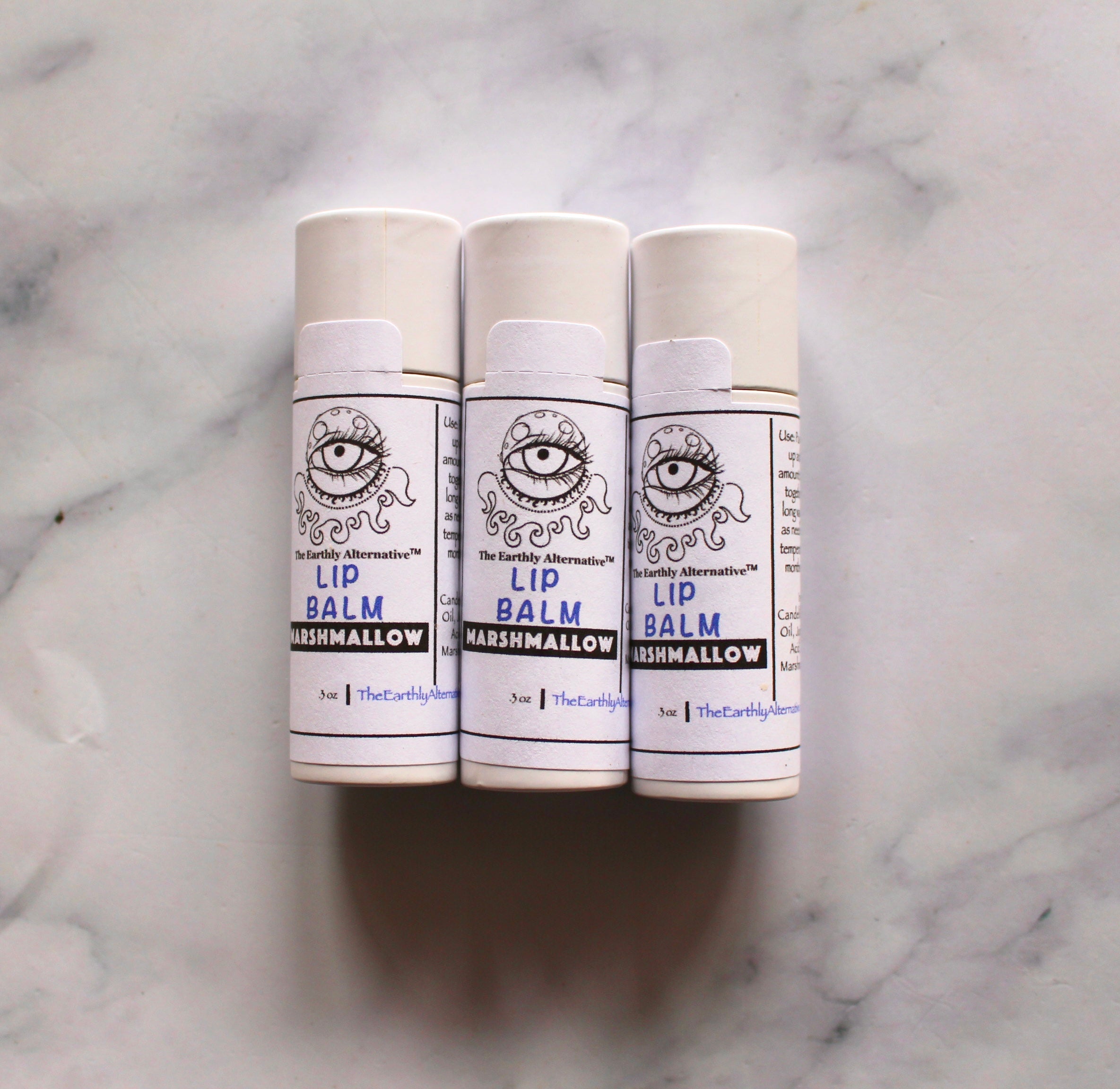 Marshmallow Mishap Lip Balm by The Earthly Alternative featuring vanilla and marshmallow scent in a sleek tube.