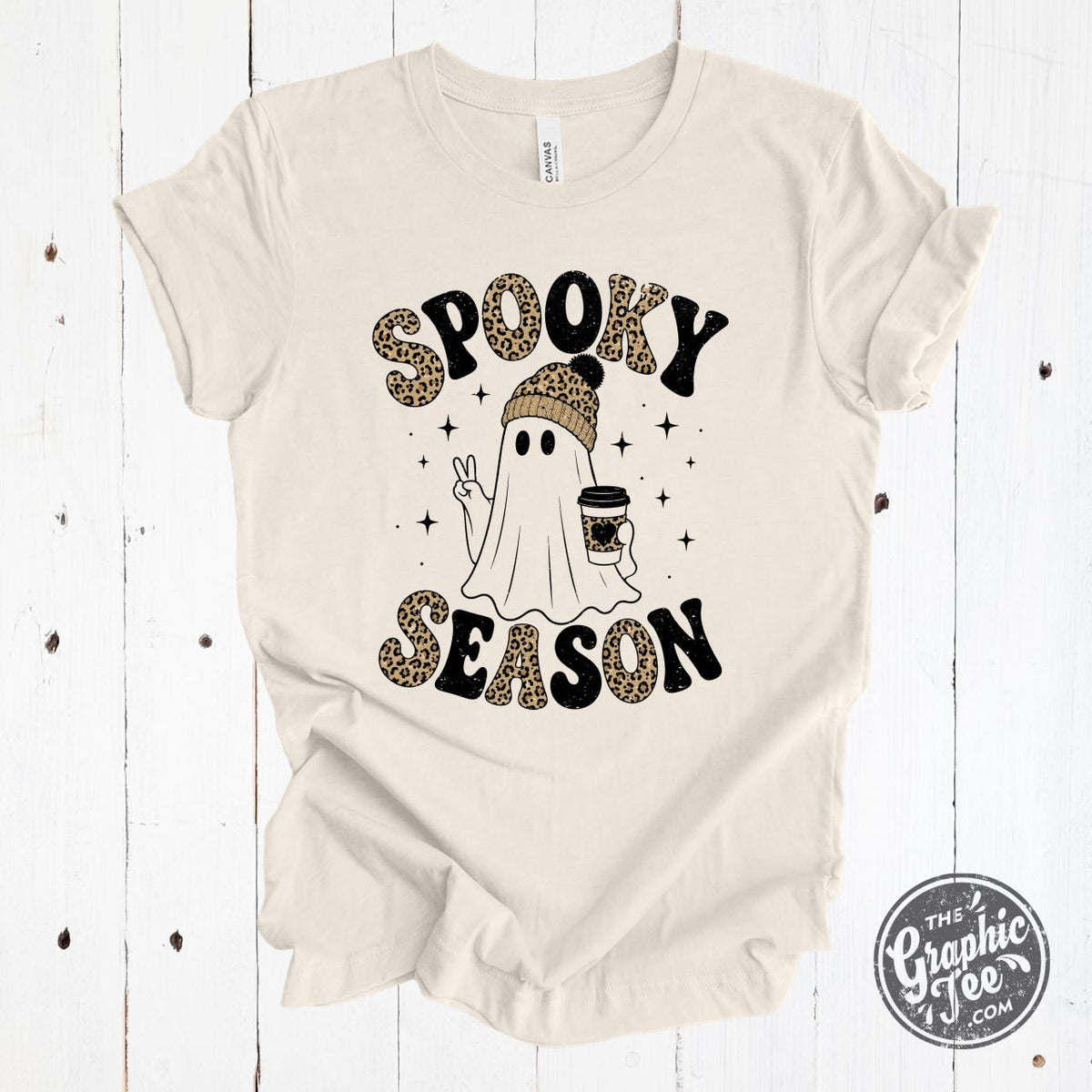 Spooky Season Leopard Adorned Ghost Crewneck Tee from The Graphic Tee, featuring a spooky ghost with leopard print details on a heather gray shirt.